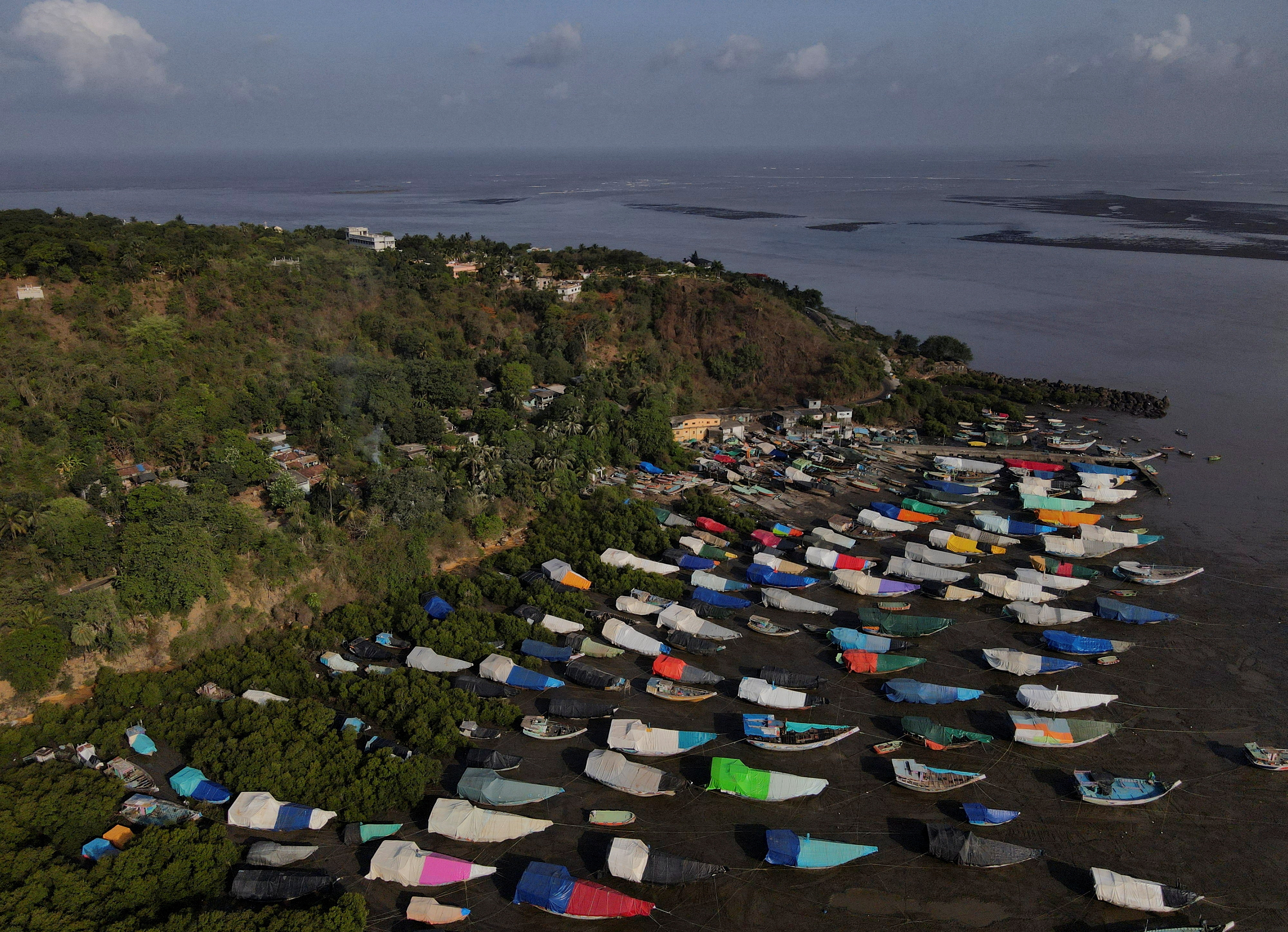 An aerial view of fishing boats covered with tarpaulin sheets parked on the shore, before the start of the monsoon season, on the outskirts of Mumbai