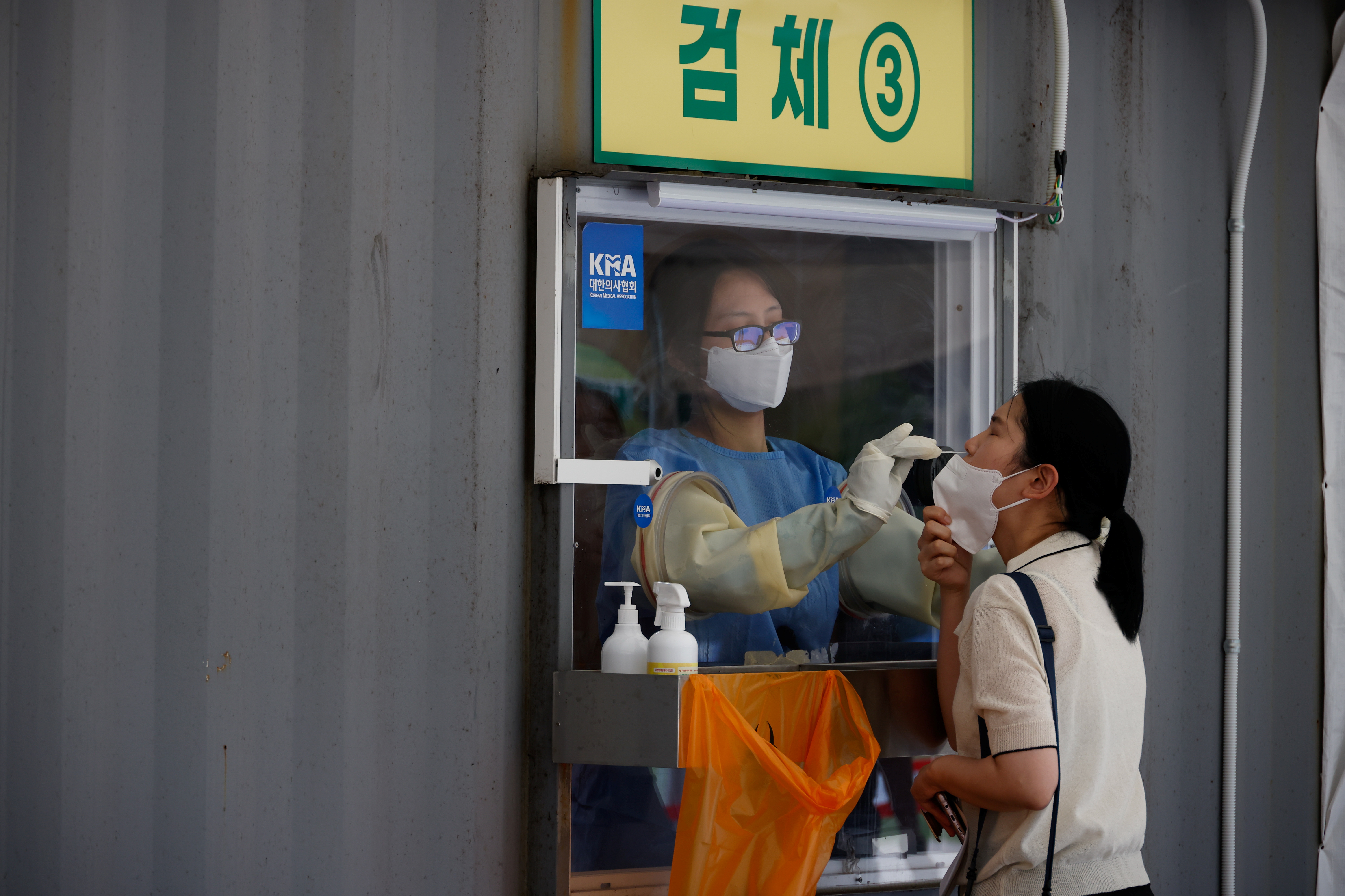 A woman gets a coronavirus disease (COVID-19) test at a coronavirus testing site in Seoul