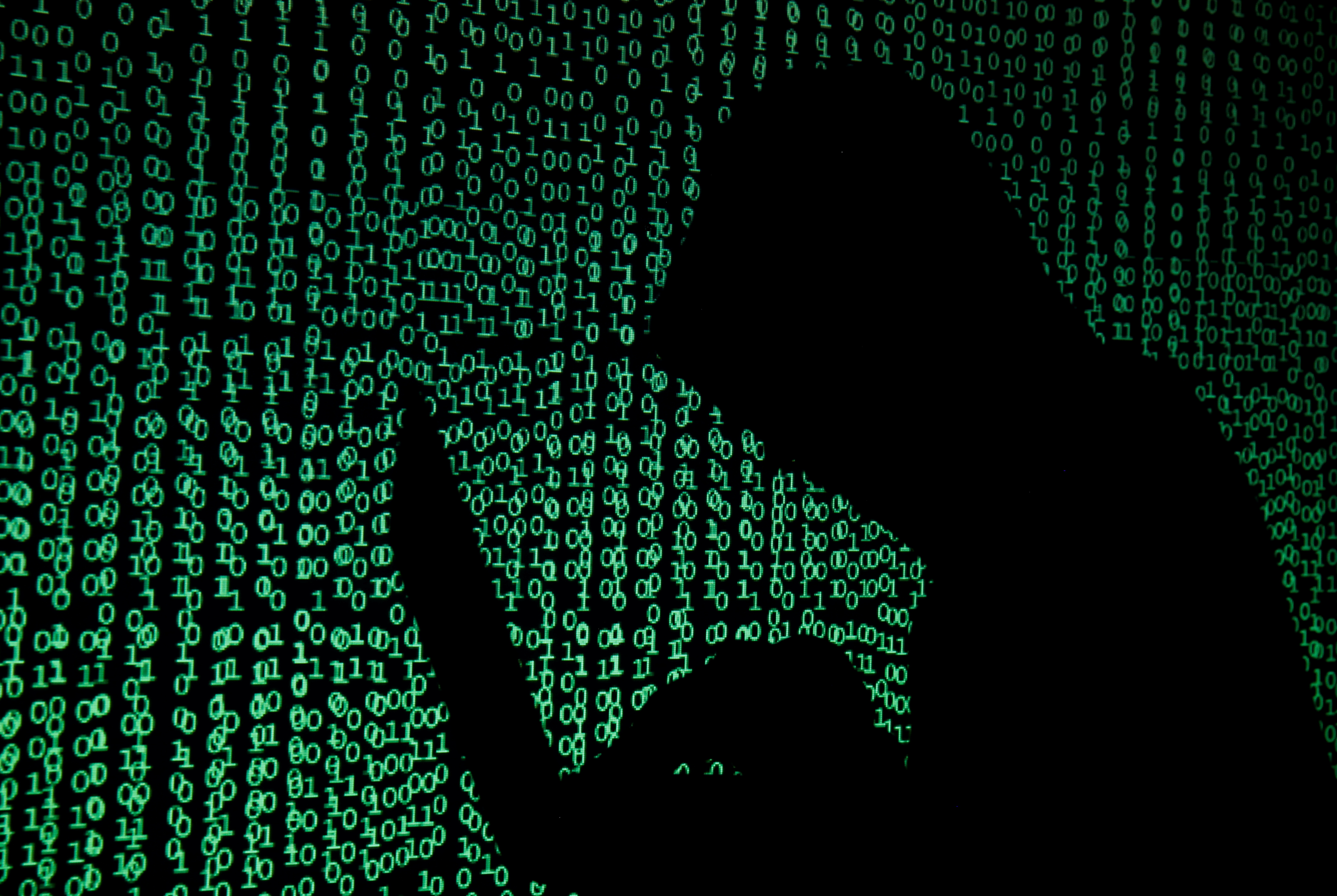 A hooded man holds a laptop computer as cyber code is projected on him in this illustration picture taken on May 13, 2017.  REUTERS/Kacper Pempel/Illustration/File Photo
