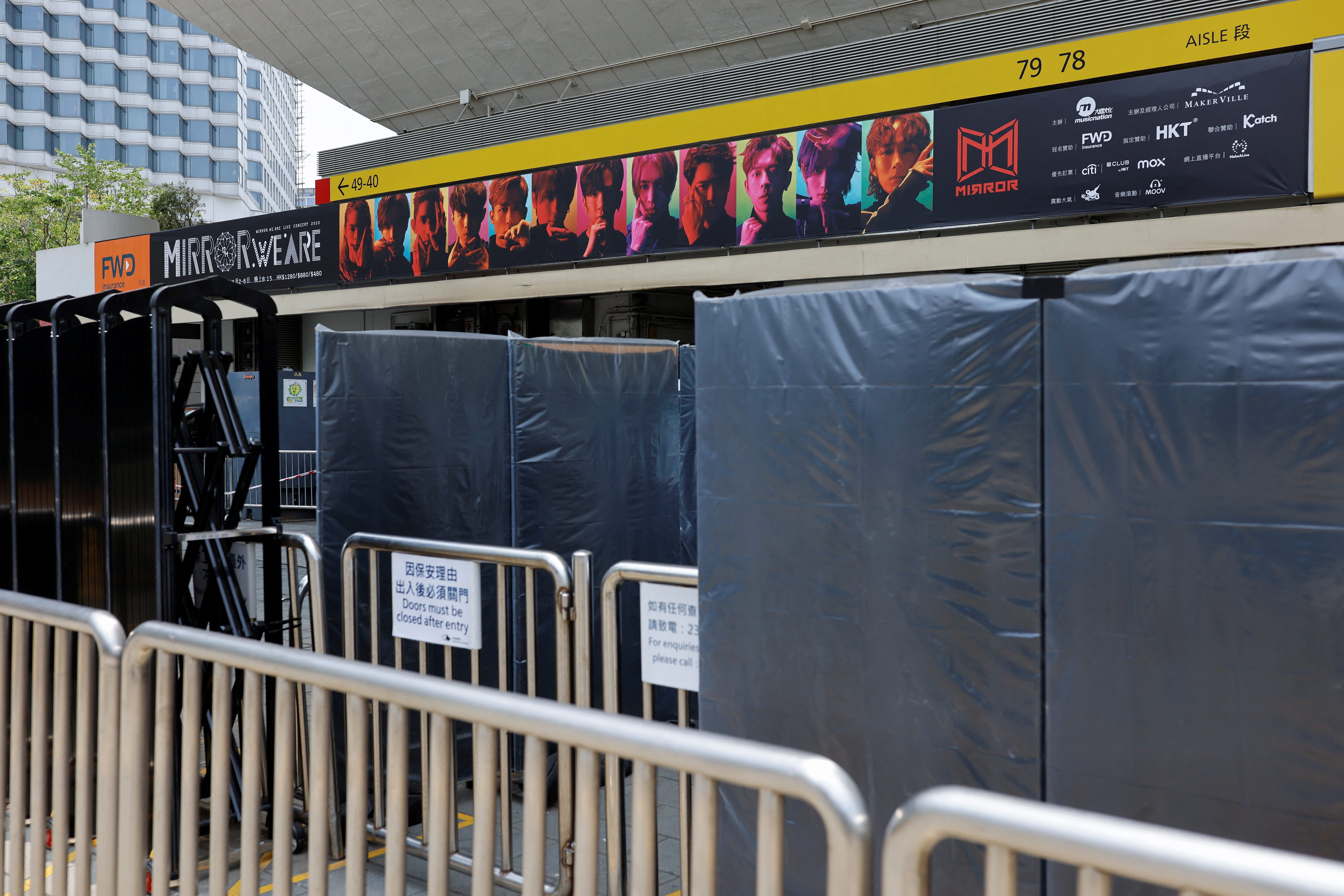 Barriers are seen outside Hong Kong Coliseum after giant video panel fell onto the stage during a concert by Hong Kong boyband Mirror, in Hong Kong