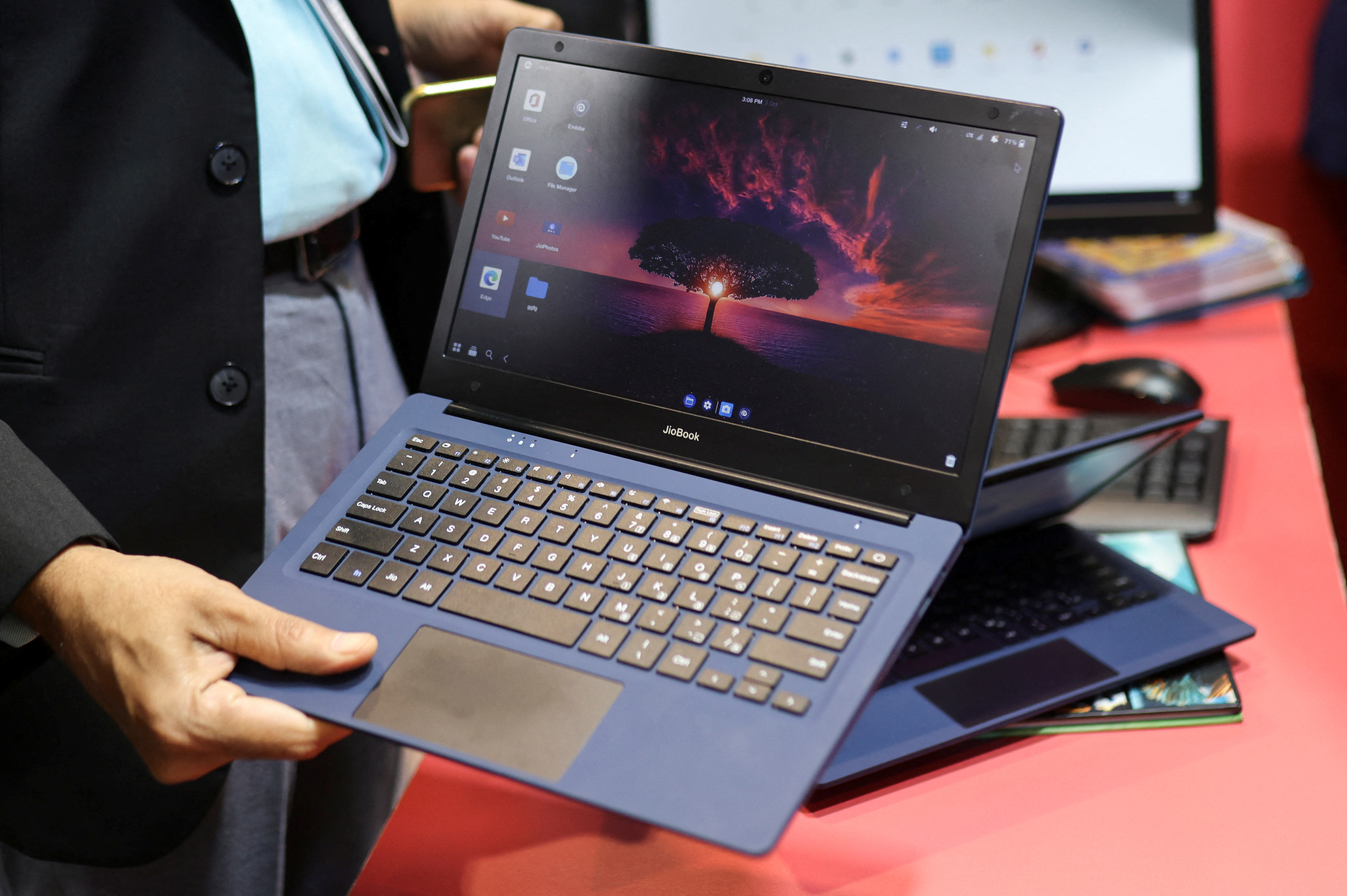 A man holds the Reliance's soon to be launched laptop called JioBook, kept on display at a stall of Jio at the ongoing India Mobile Congress 2022, at Pragati Maidan, in New Delhi