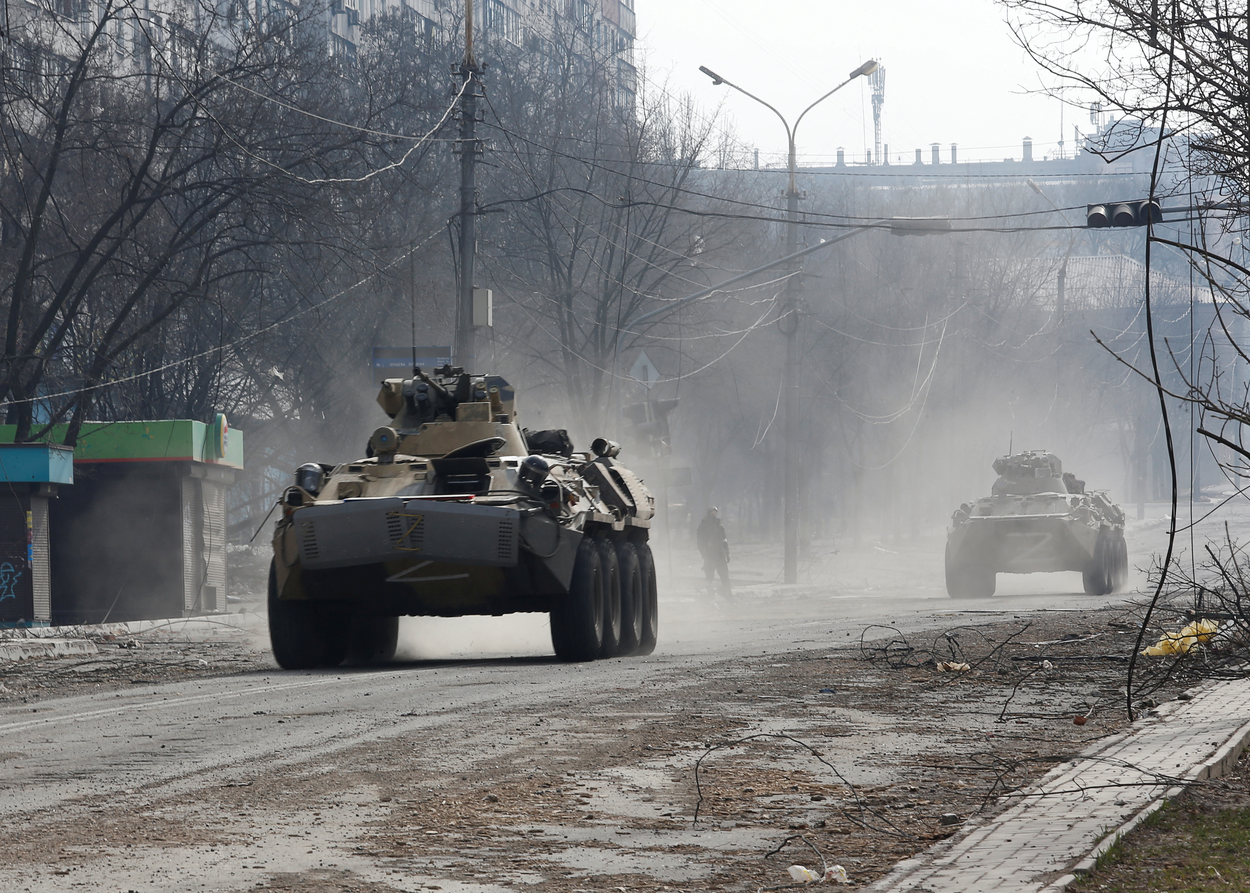 Armoured vehicles of pro-Russian troops drive along a street in Mariupol