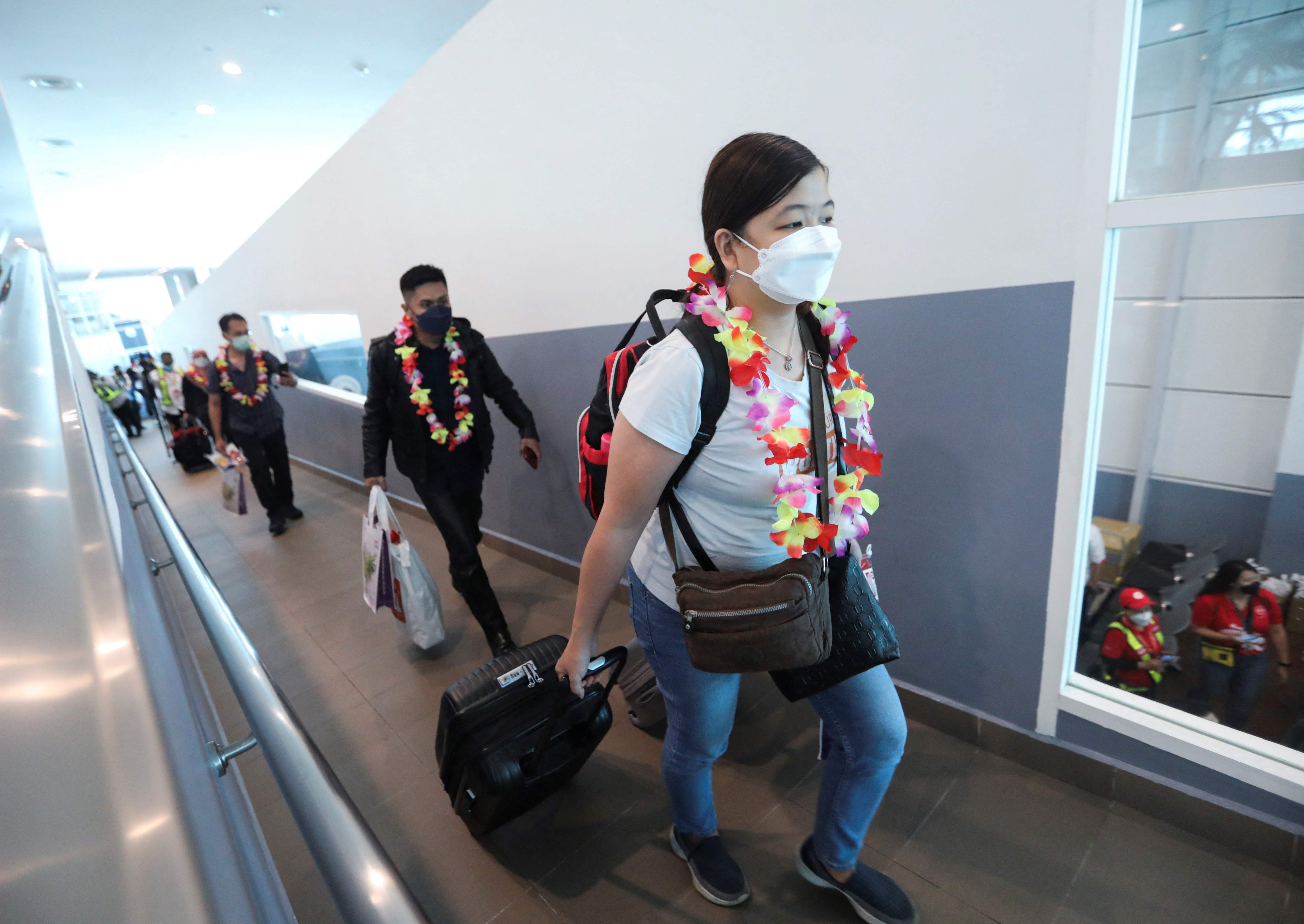 Travellers disembark from an airplane from Jakarta, Indonesia at Kuala Lumpur International Airport 2 (KLIA2) in Sepang
