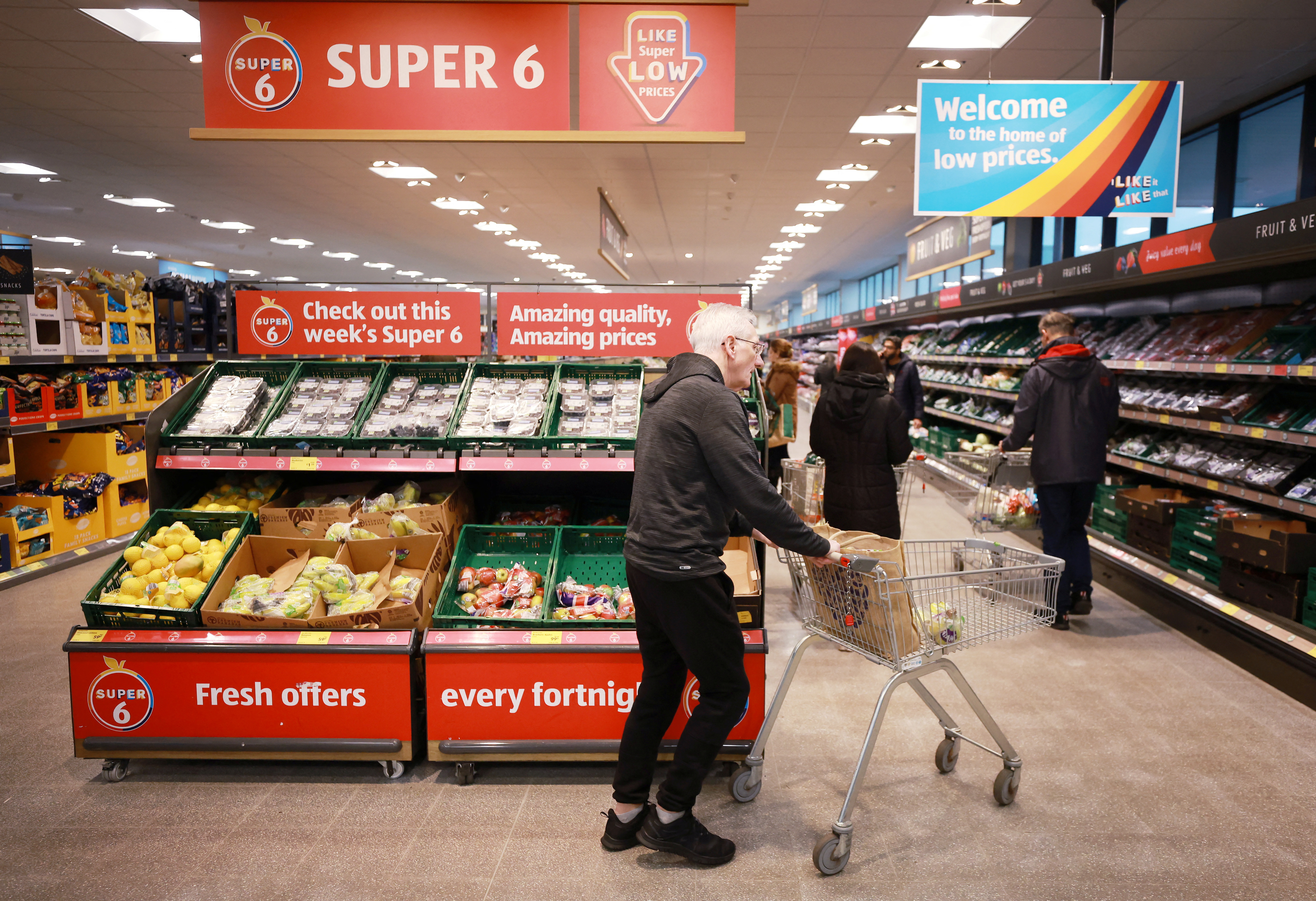 Shopper walks inside an ALDI supermarket near Altrincham