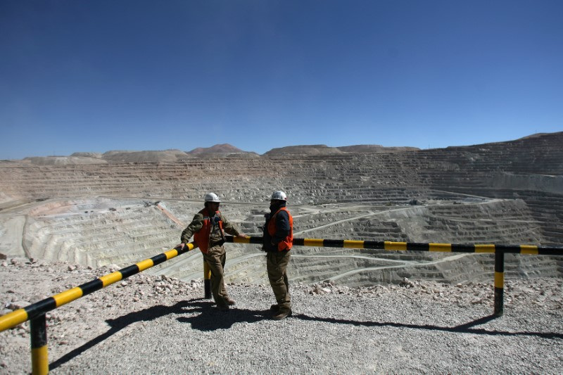 Workers of BHP Billiton's Escondida, the world's biggest copper mine, are seen in front of the open pit, in Antofagasta