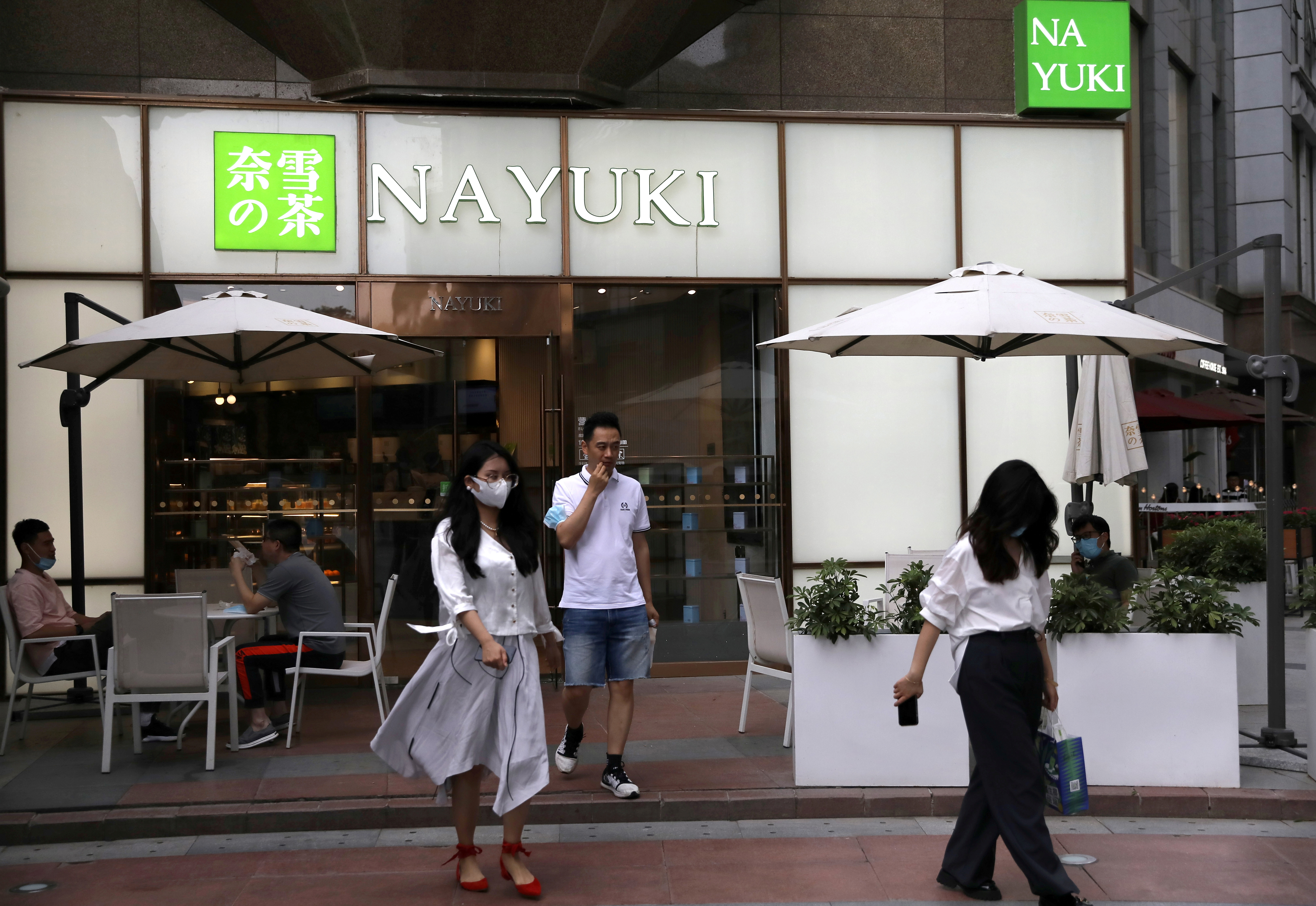 Customers leave a store of Chinese bubble tea chain Nayuki in Beijing