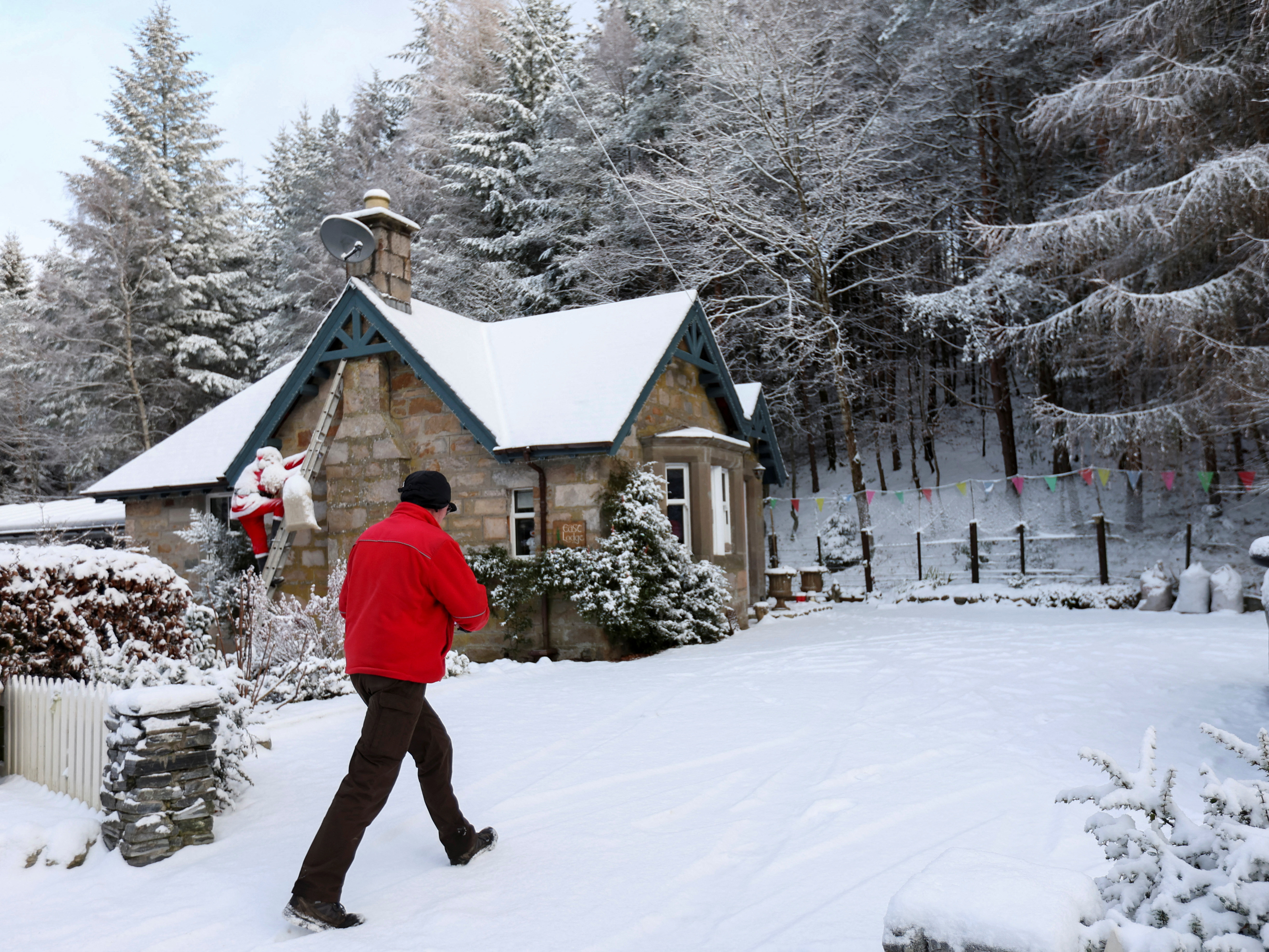 Royal Mail postman makes a delivery in Pitlochry, Scotland