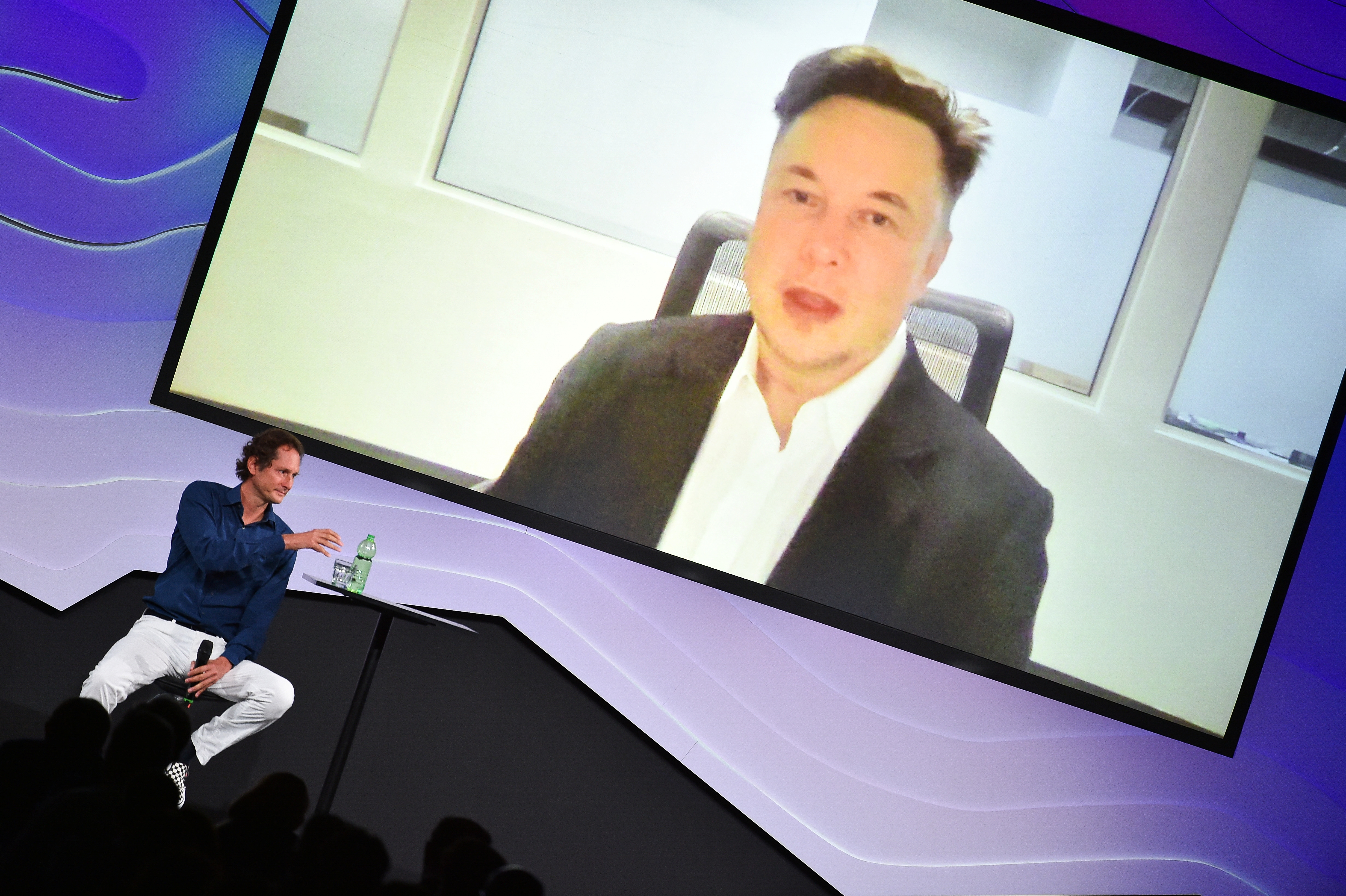 Chairman of Stellantis and Ferrari John Elkann speaks via video conference with Tesla's founder Elon Musk in Turin