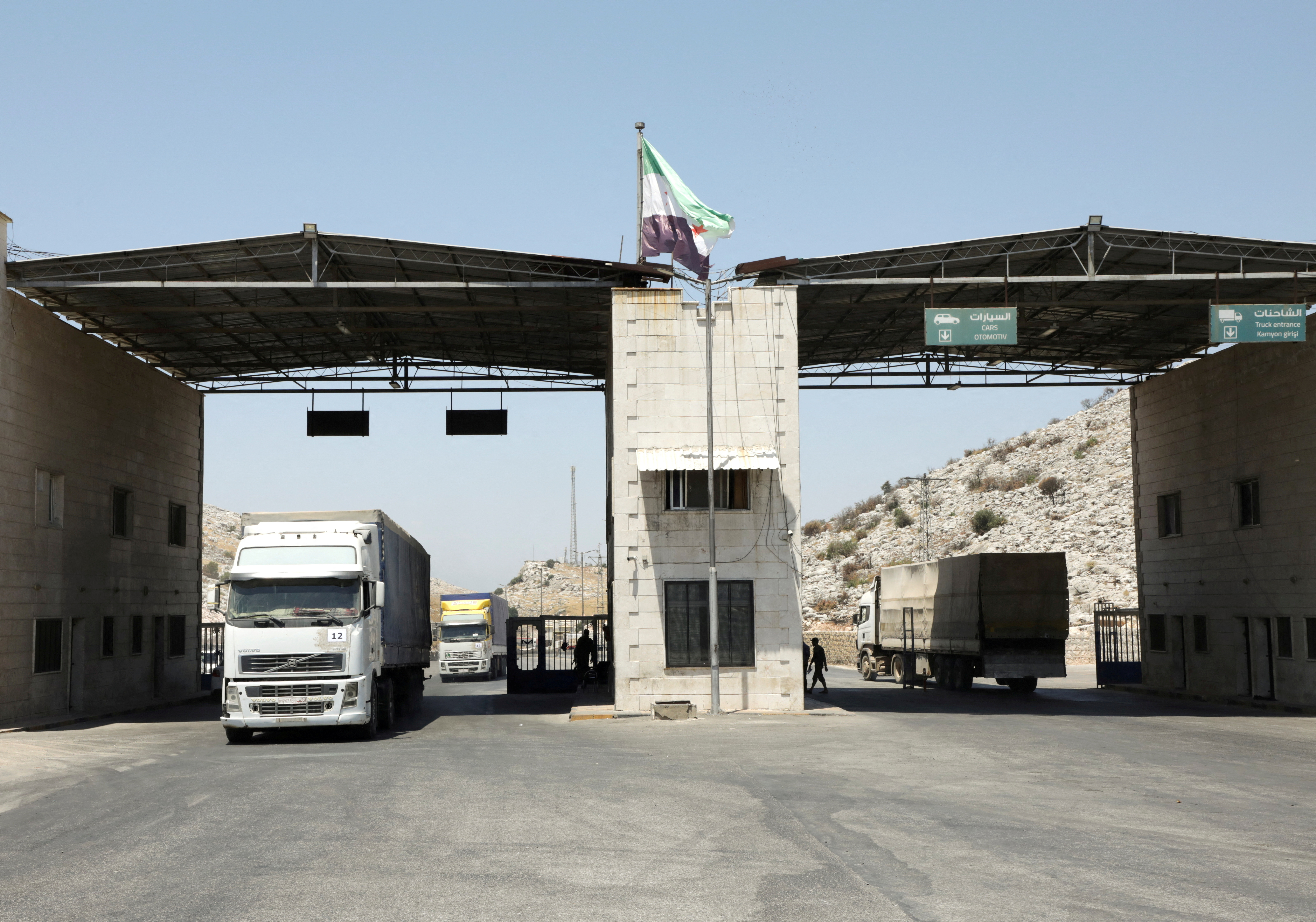 Trucks drive at Bab al-Hawa crossing at the Syrian-Turkish border, in Idlib governorate
