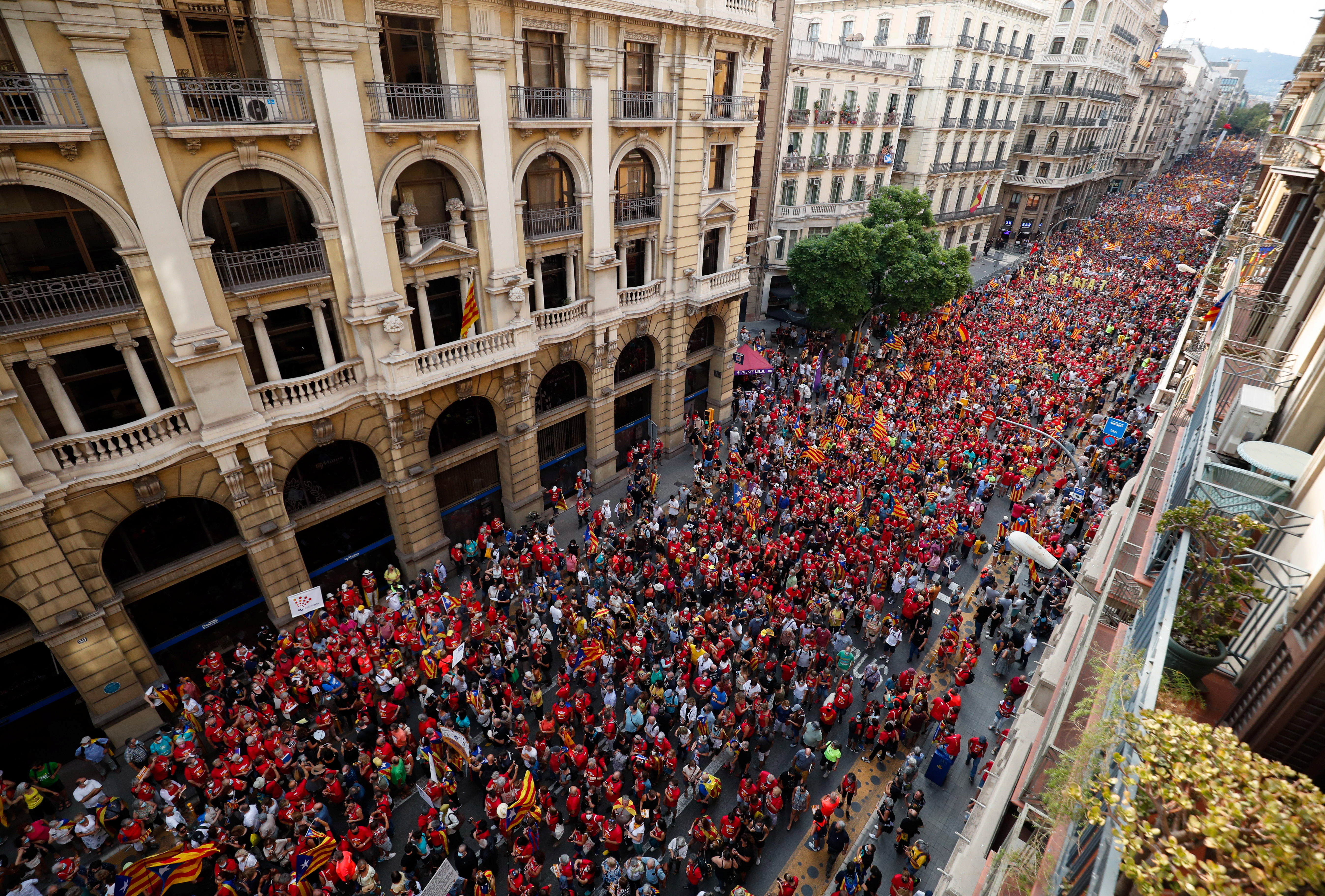 People hold up Estelada flags (Catalan separatist flag) during Catalonia's national day, 'La Diada', in Barcelona, Spain, September 11, 2021. REUTERS/ Albert Gea