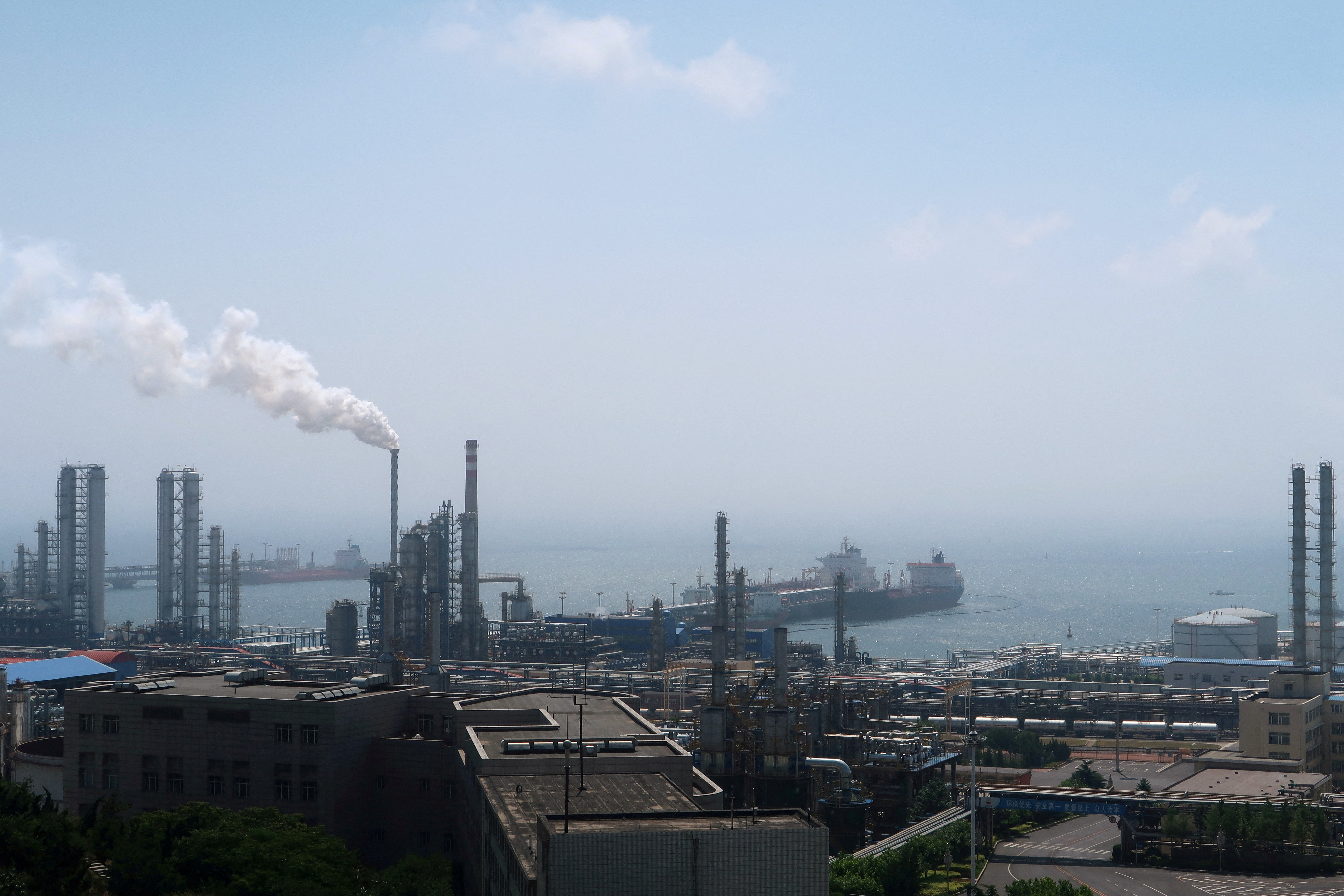 China National Petroleum Corporation's Dalian Petrochemical Corp refinery is seen near the downtown of Dalian