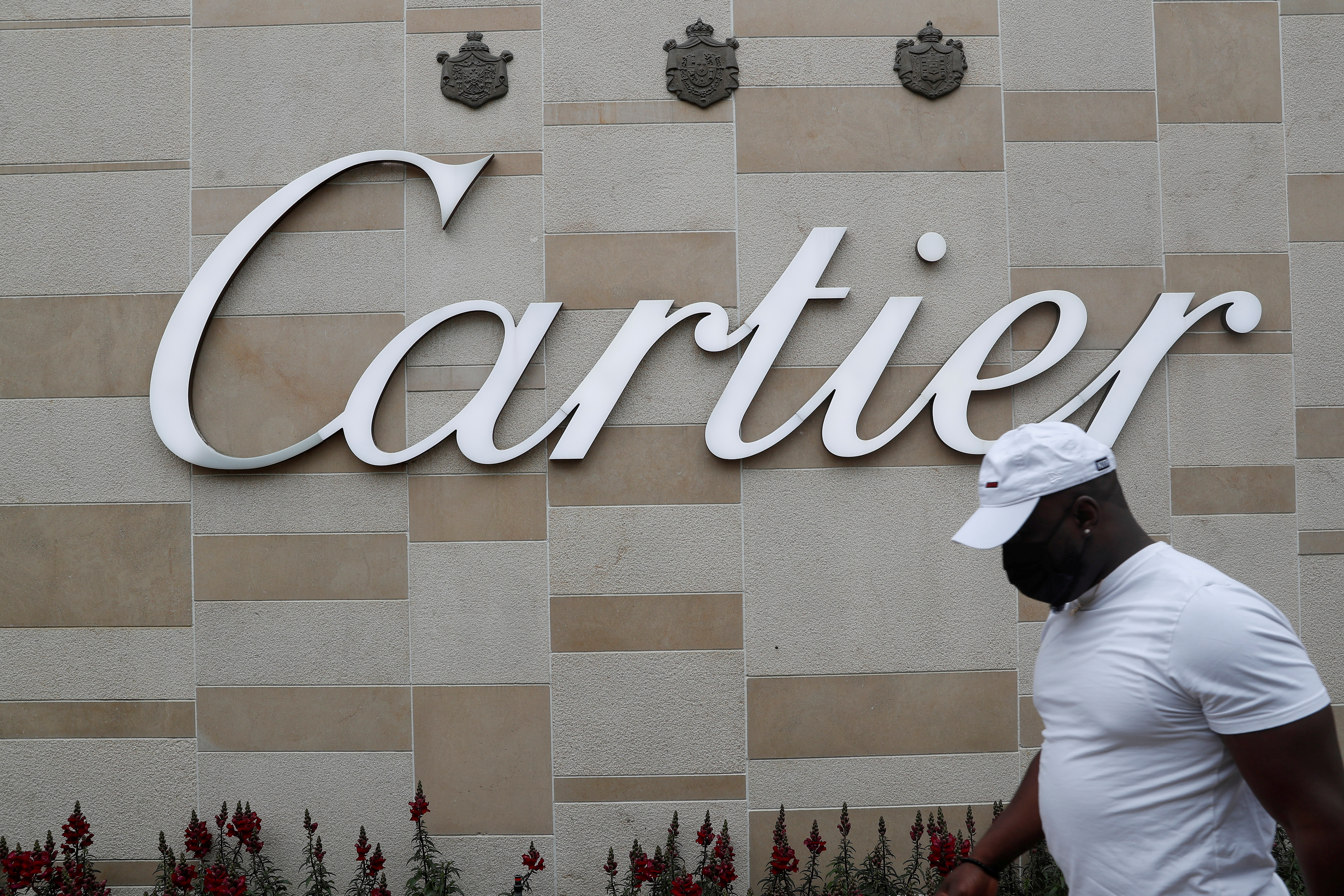 Man walks by luxury Cartier jewelry store in Manhasset, New York