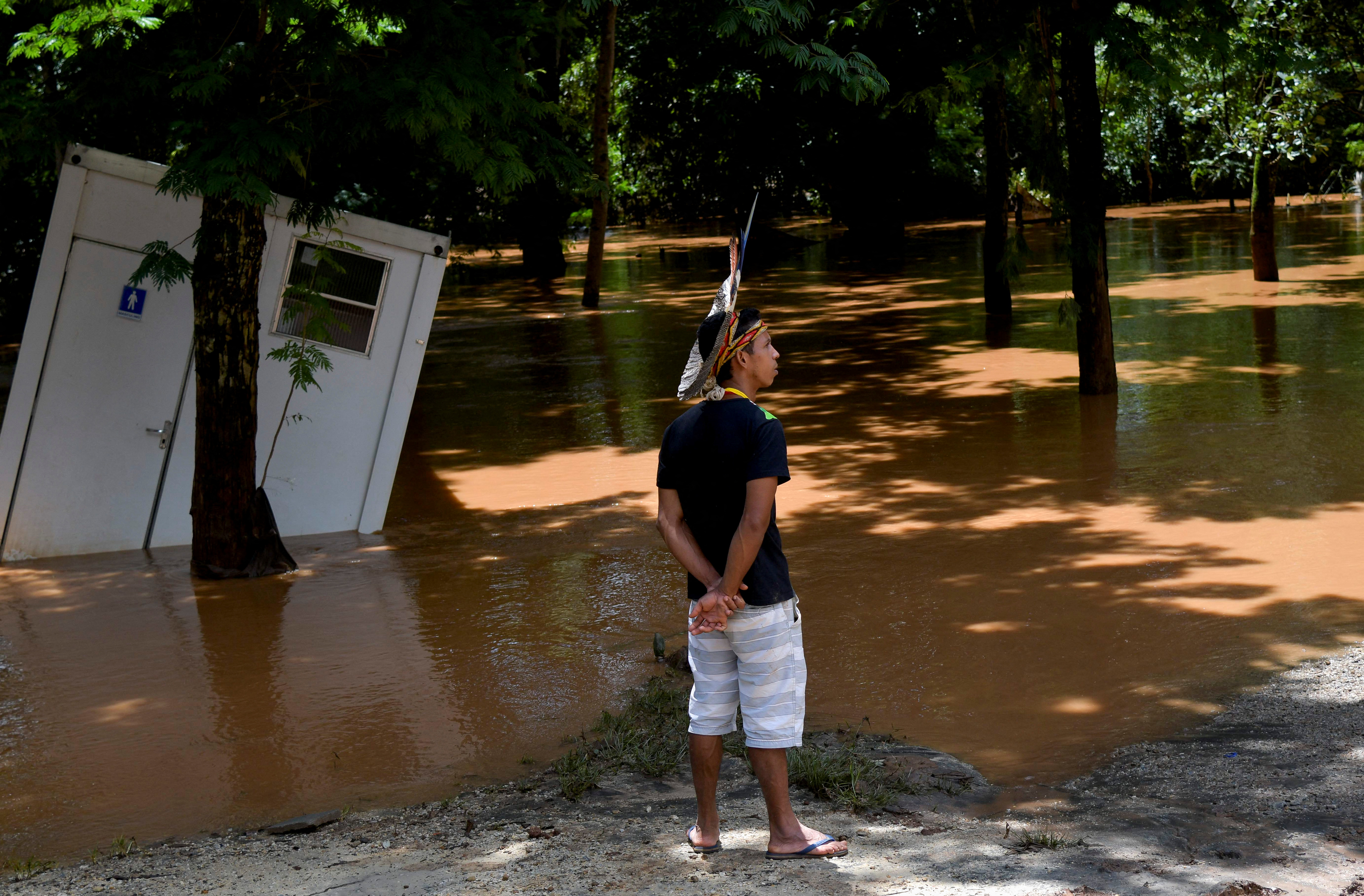 Indigenous leader Vice Cacique Sucupira of the Pataxo ethnicity observes flooding in Nao Xoha village after pouring rains, in Sao Joaquim de Bicas, Minas Gerais state, Brazil January 12, 2022. REUTERS/Washington Alves