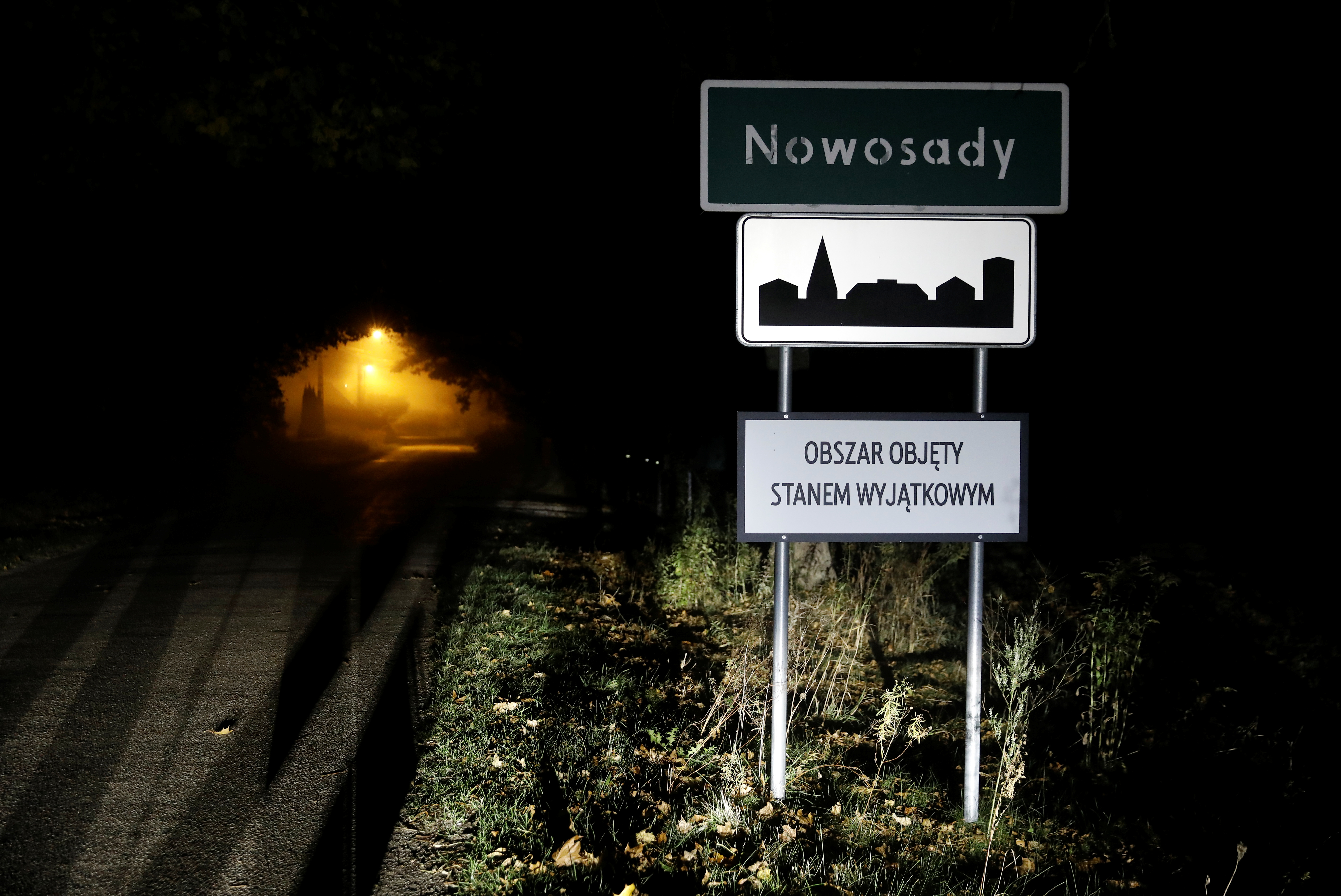 Road sign with 'Area covered by a state of emergency' is seen near Belarusian-Polish border in Nowosady, Poland October 12, 2021. Picture taken October 12, 2021. REUTERS/Kacper Pempel