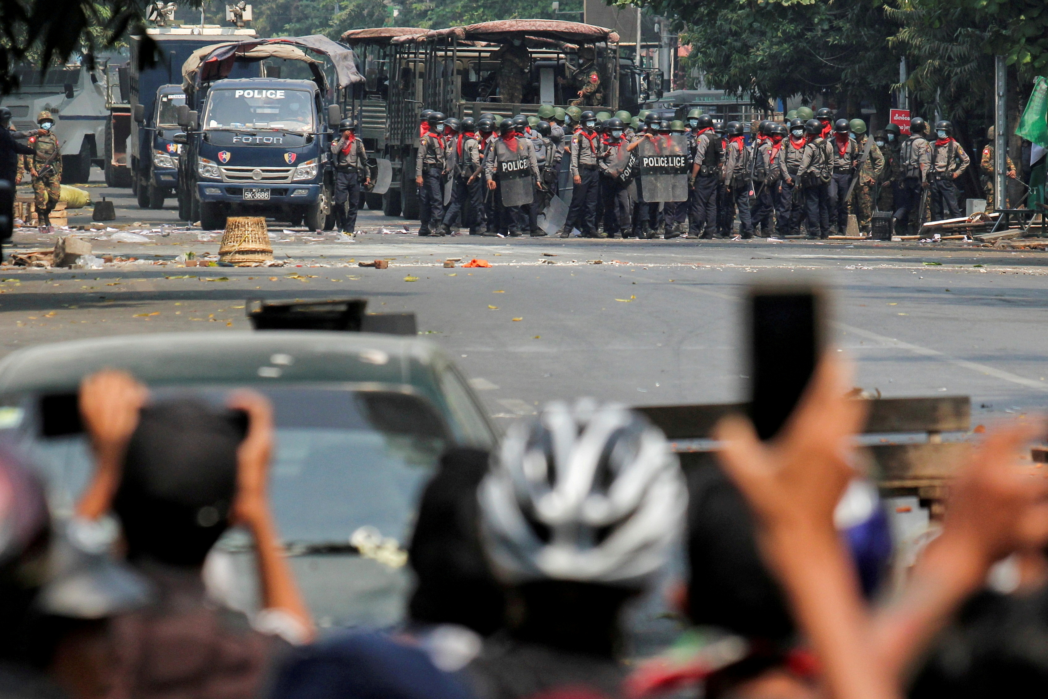 FILE PHOTO: Police stand on a road during an anti-coup protest in Mandalay