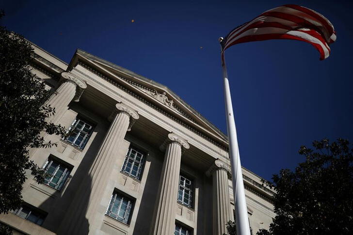 American flag waves outside the U.S. Department of Justice Building in Washington