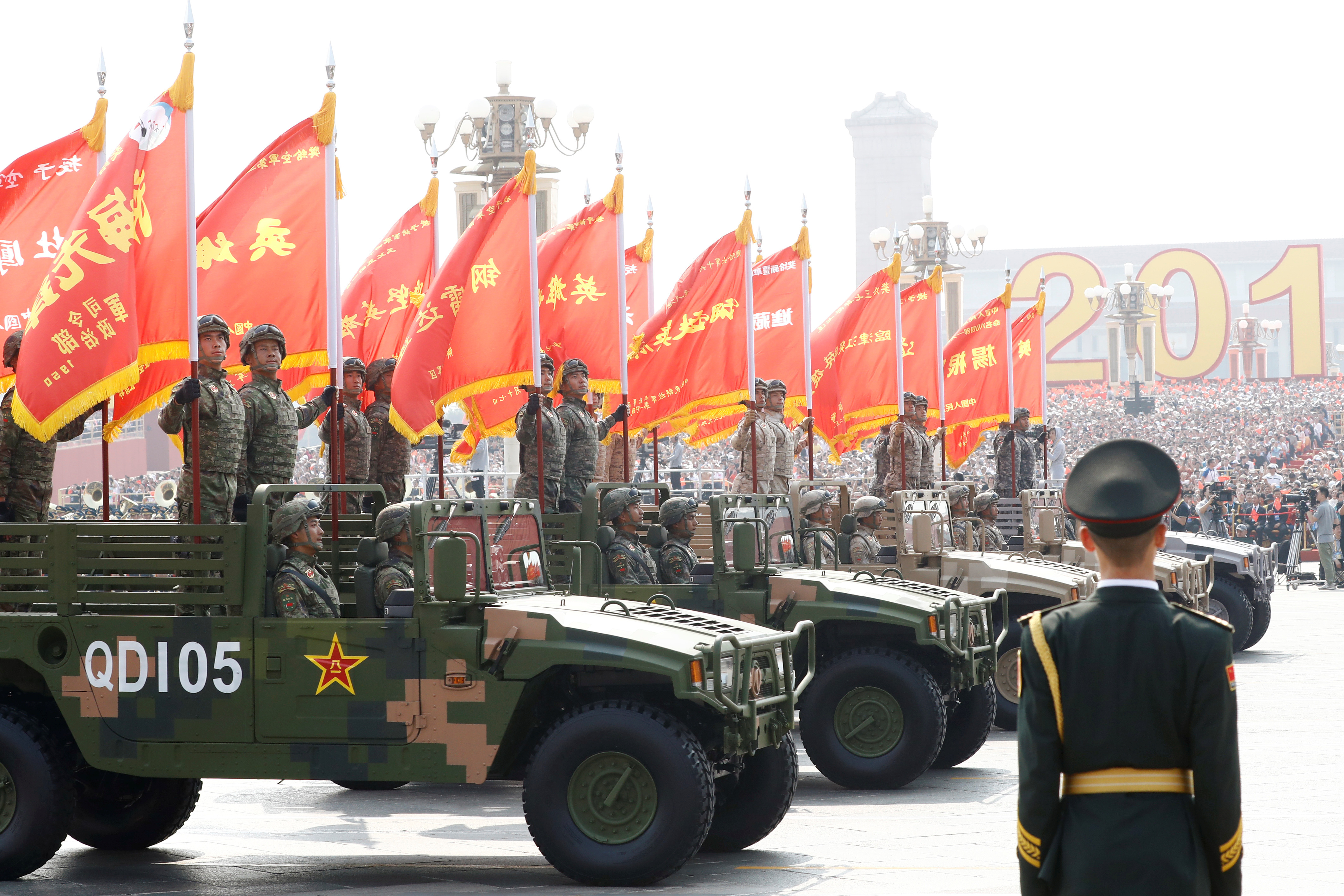 Troops in military vehicles take part in the military parade marking the 70th founding anniversary of People's Republic of China, on its National Day in Beijing