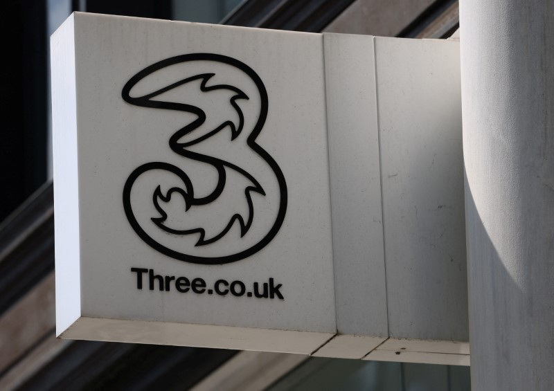 Branding is displayed for mobile company Three at one of its stores in London