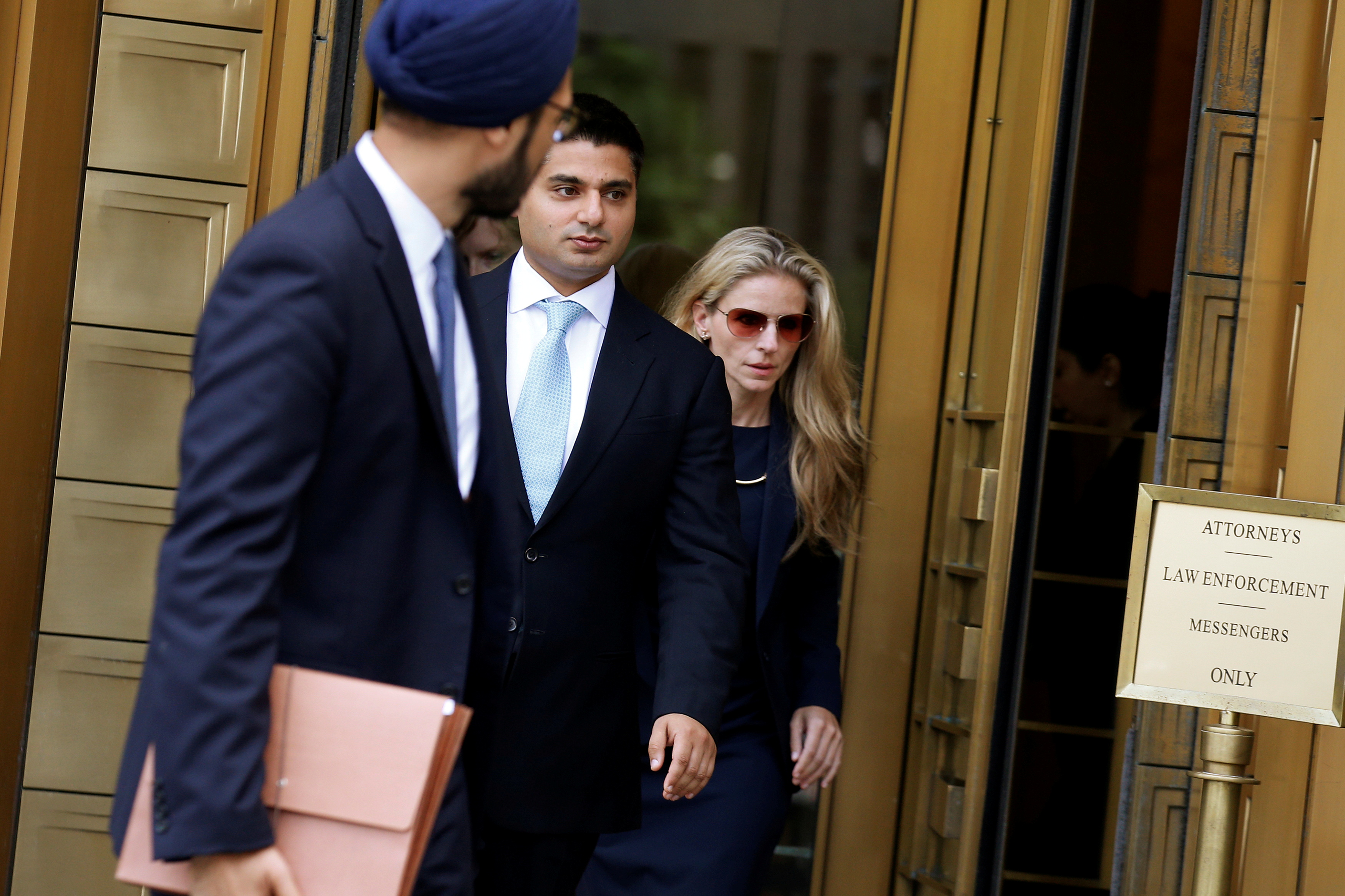 Rohan Ramchandani (center), former London-based trader for Citigroup Inc, exits the U.S. Federal Court in Manhattan following a hearing for conspiring to rig prices in the foreign exchange market in New York City, U.S., July 17, 2017. REUTERS/Brendan McDermid/File Photo