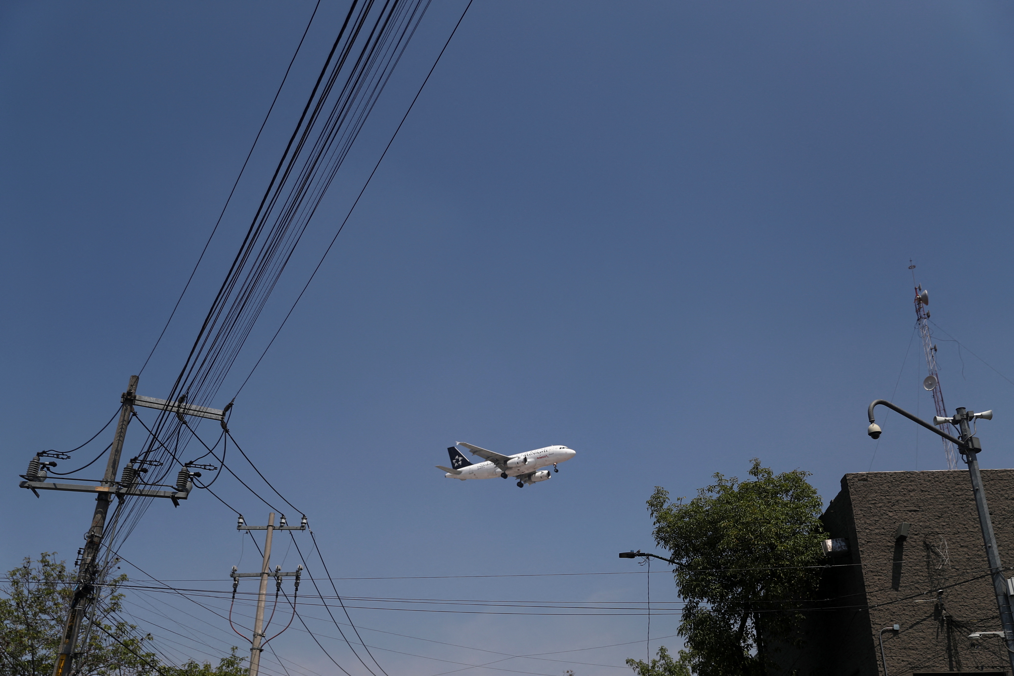 An airplane prepares to land on the airstrip at Benito Juarez international airport in Mexico City