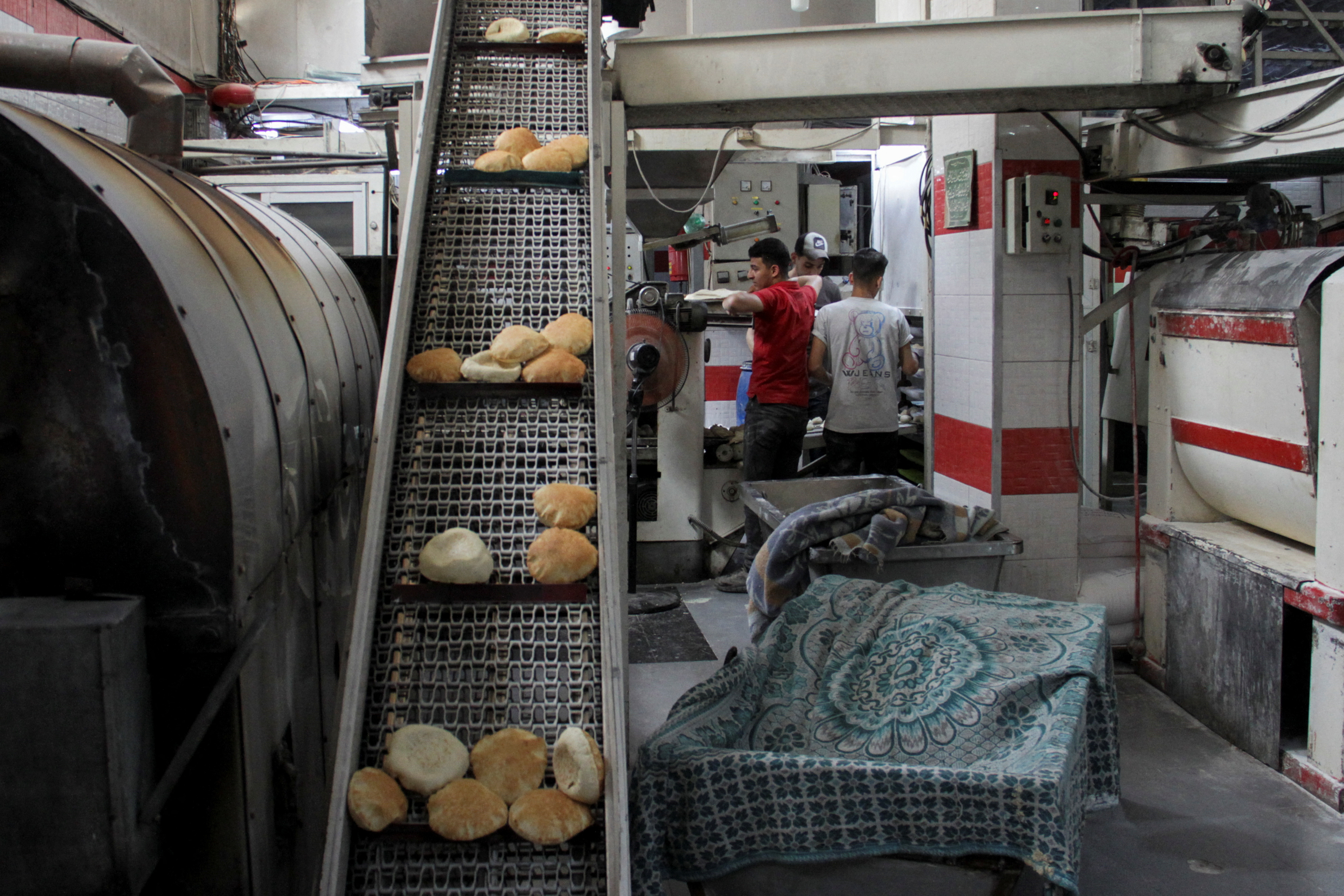 Palestinians work at recently reopened Ajour bakery, amid the ongoing conflict between Israel and Hamas, in Gaza City