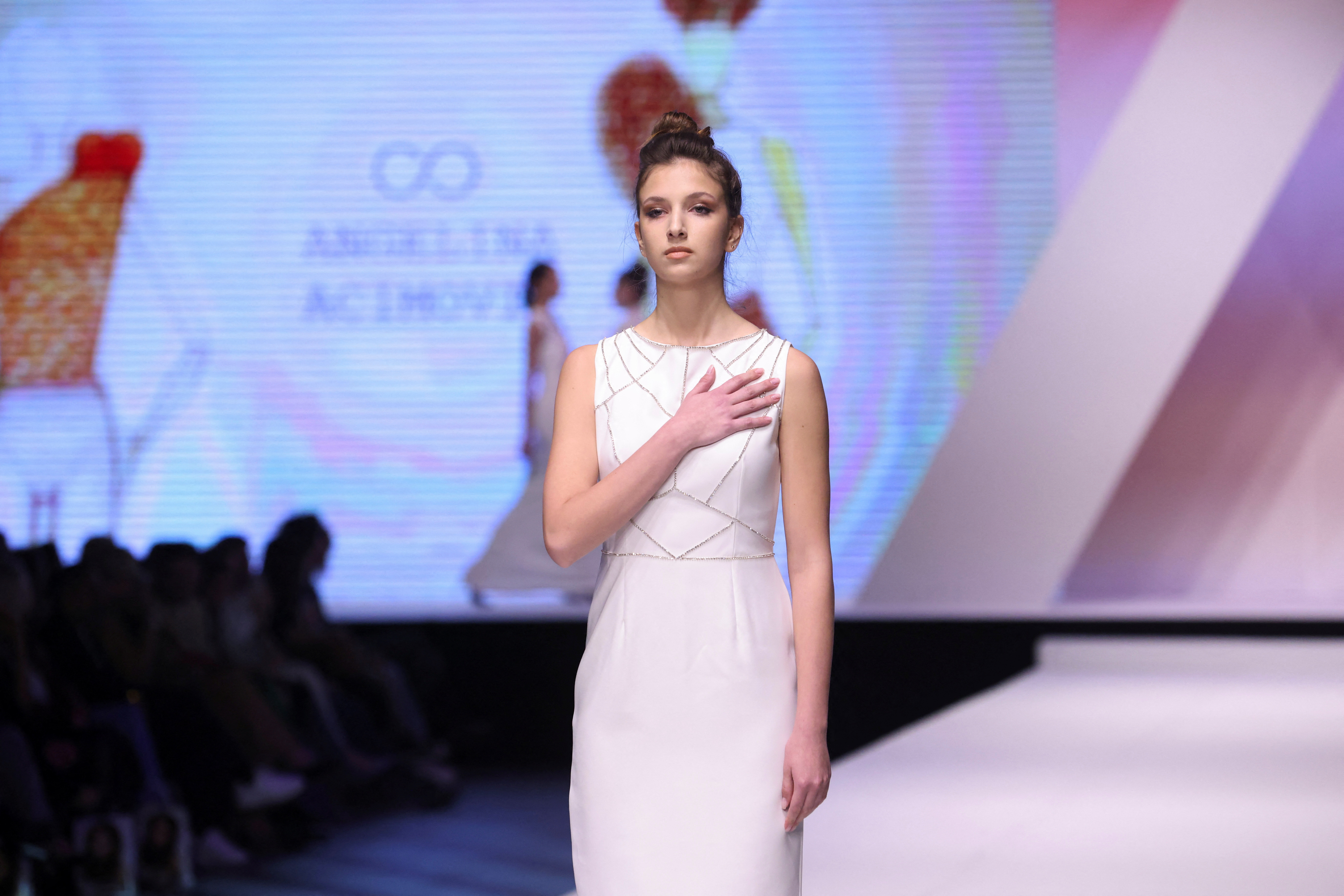 Dresses based on drawings of a victim of Serbia's school shooting are presented during a Fashion Week in Belgrade