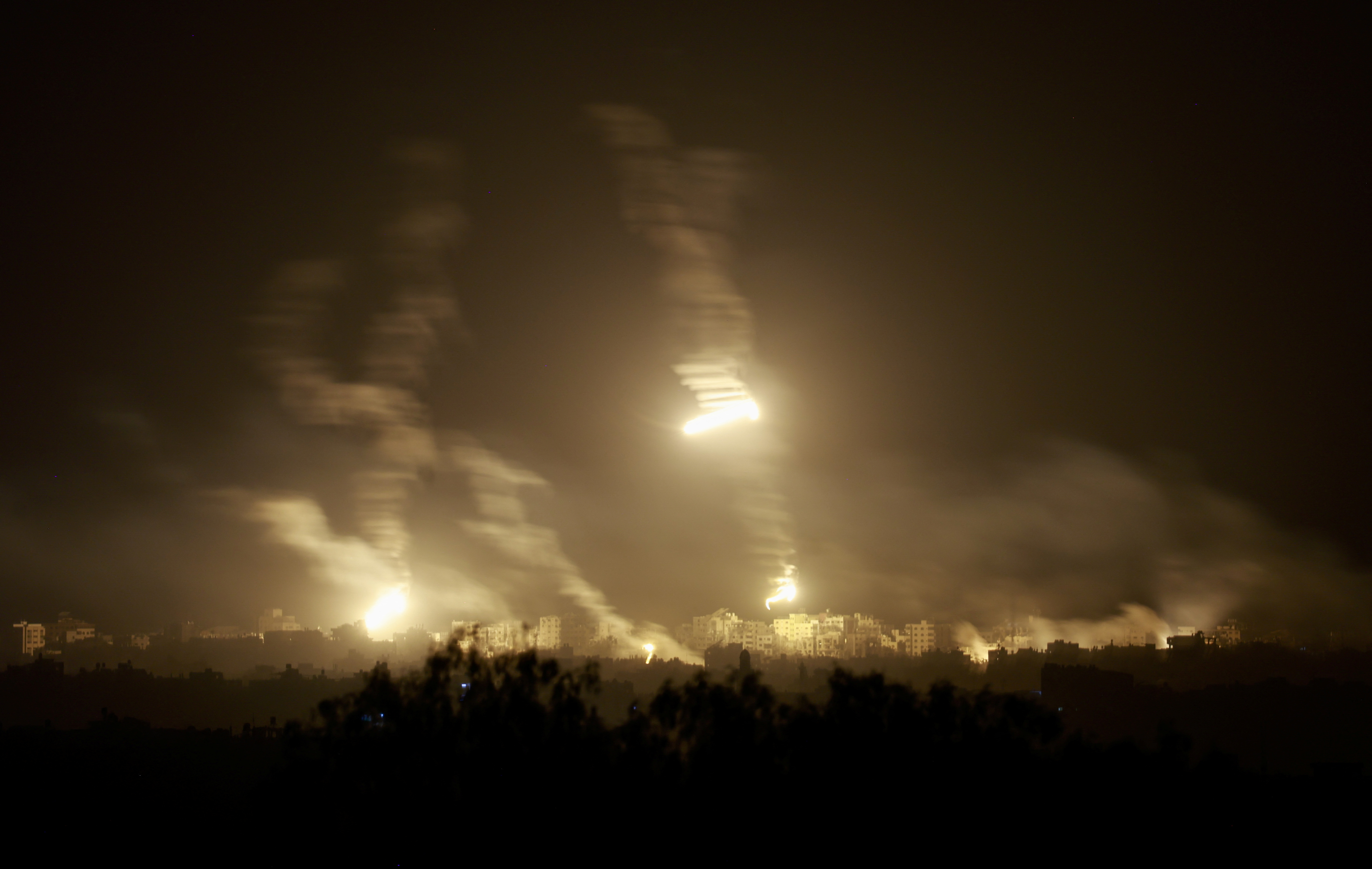 Flares burn in the sky over northern Gaza Strip, as seen from Sderot in southern Israel