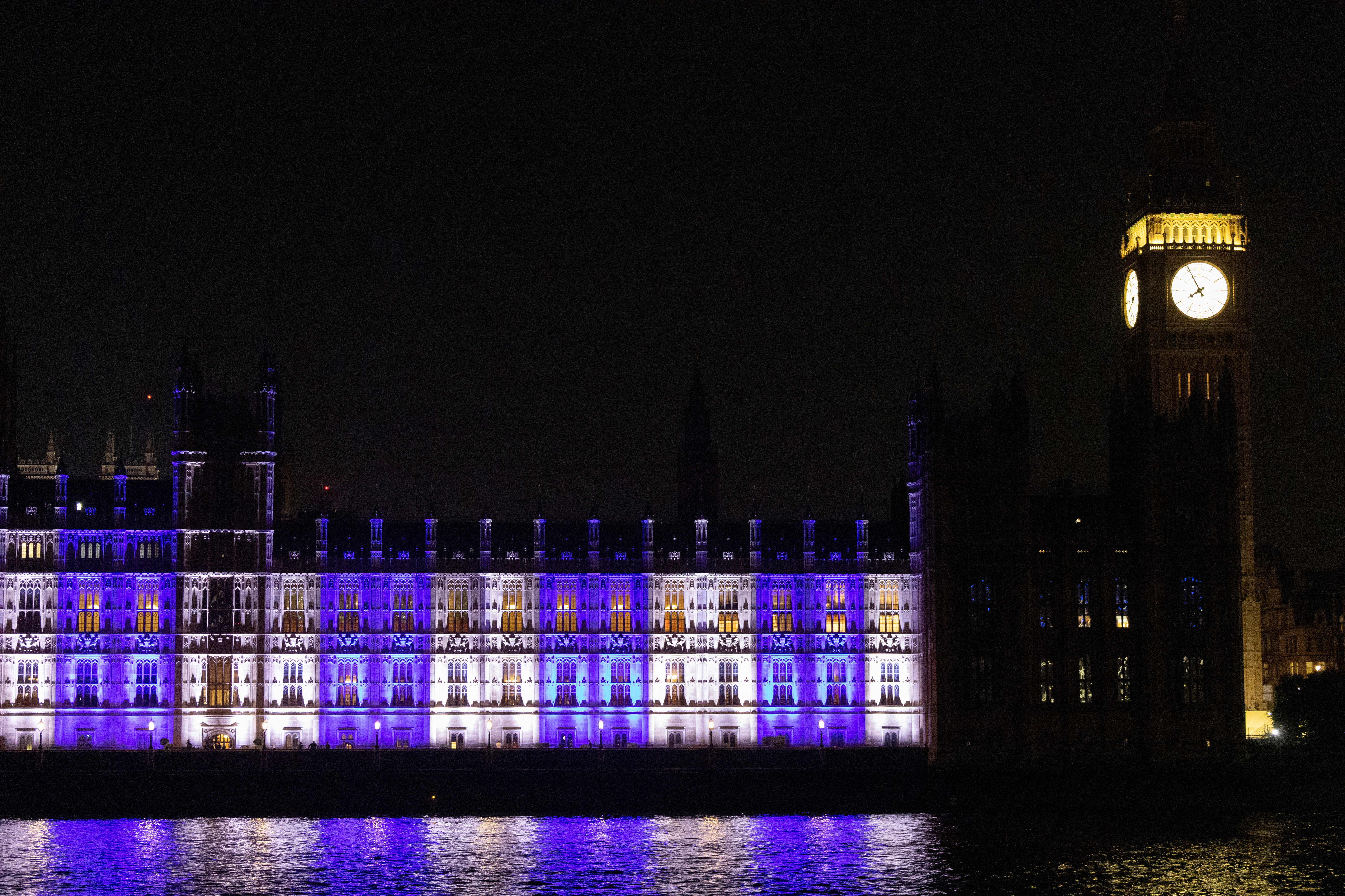 House of Commons illuminated in the colours of the flag of Israel, in London