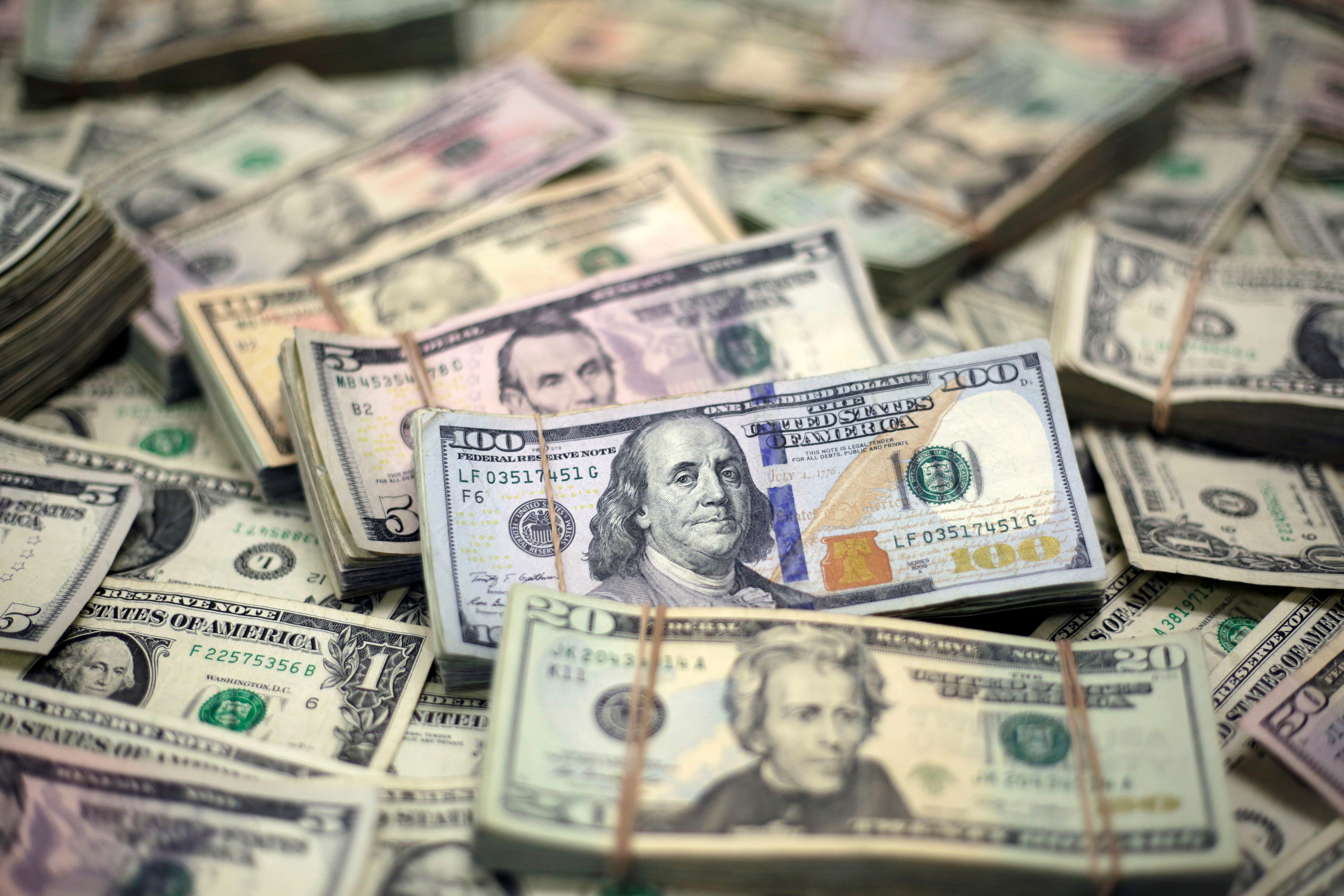 U.S. dollar banknotes are seen in this photo illustration