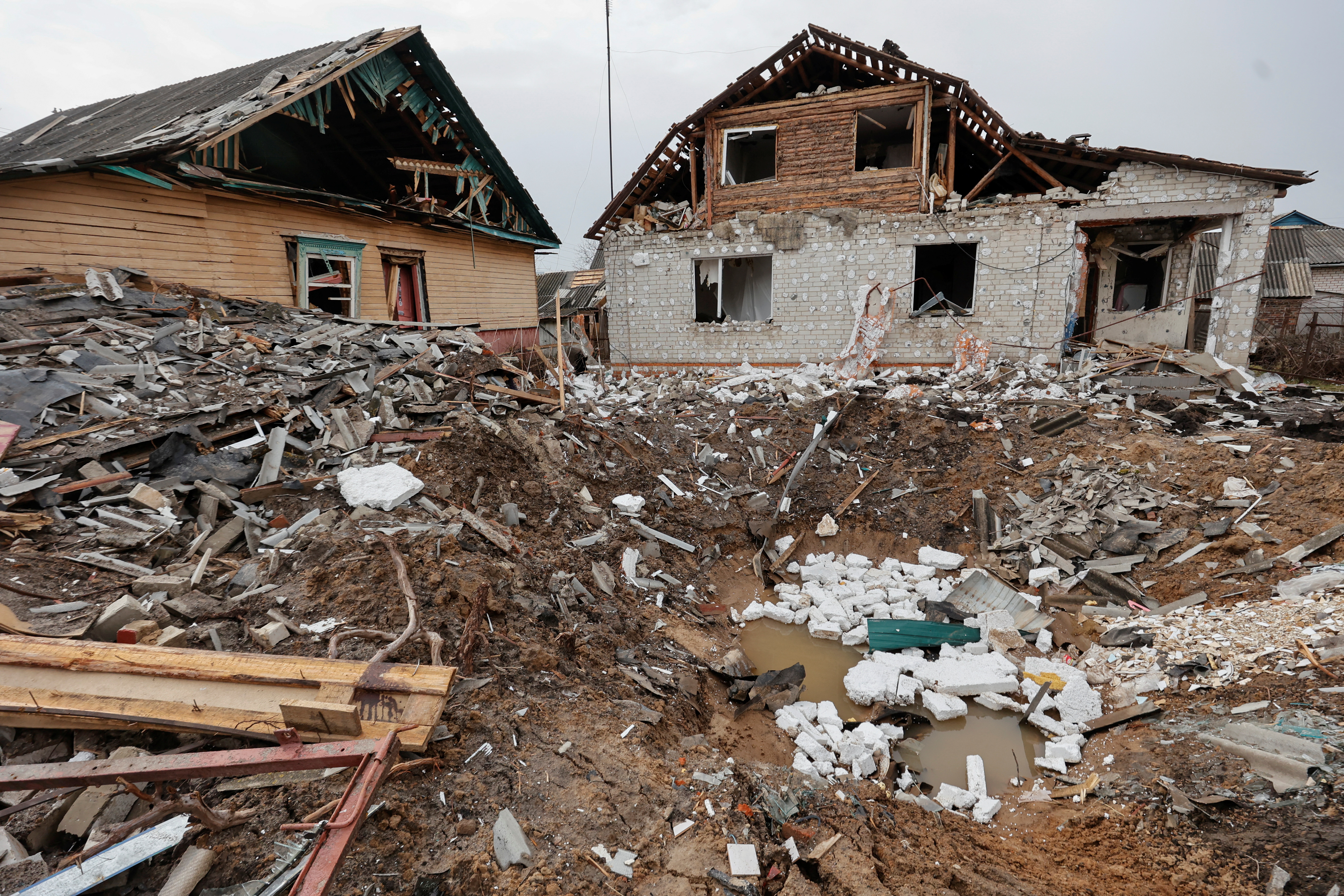 Residential houses and bomb crater are seen in Chernihiv