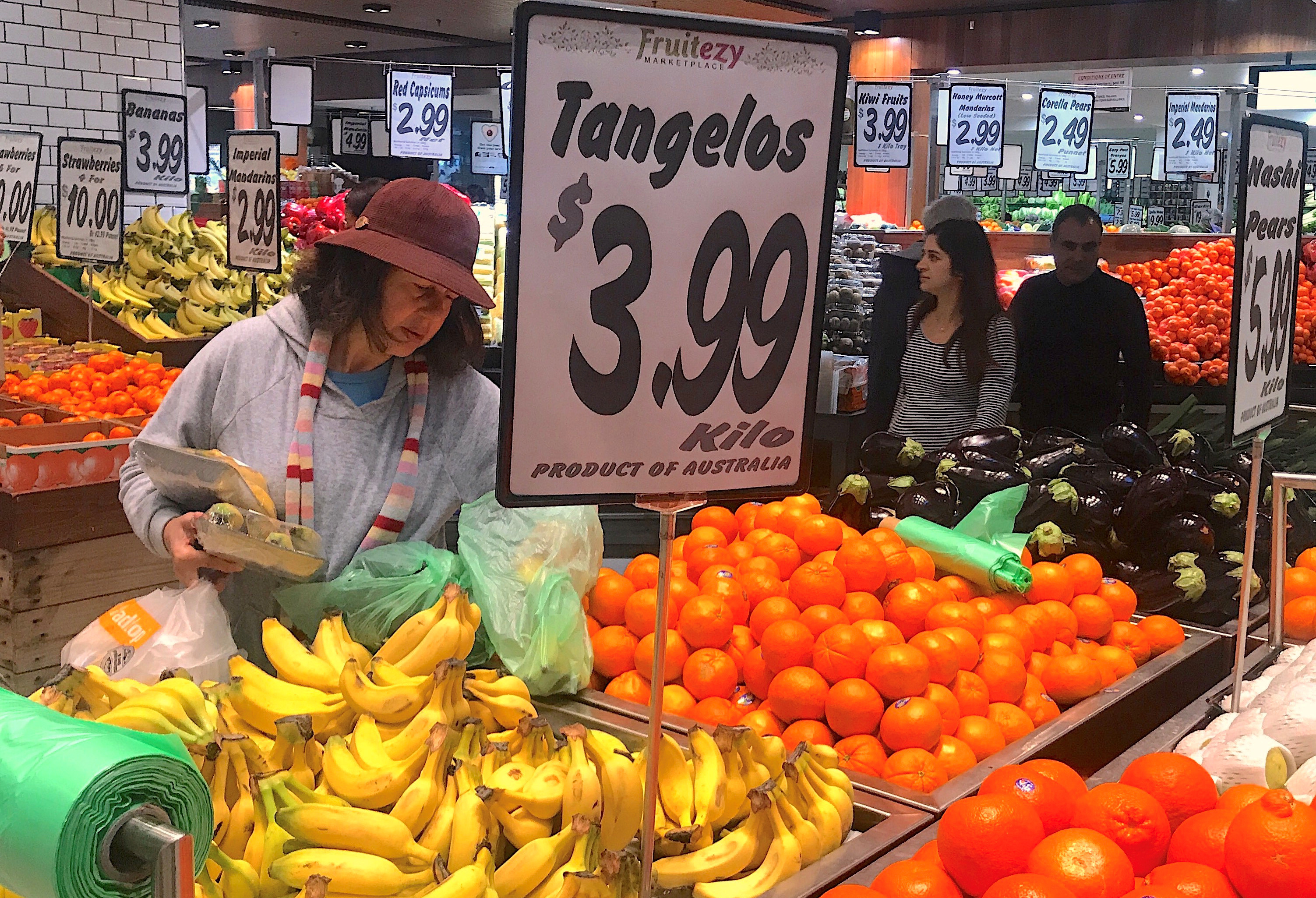 Shoppers look at a range of fruit and vegetables on sale at a store in a shopping mall in Sydney, Australia
