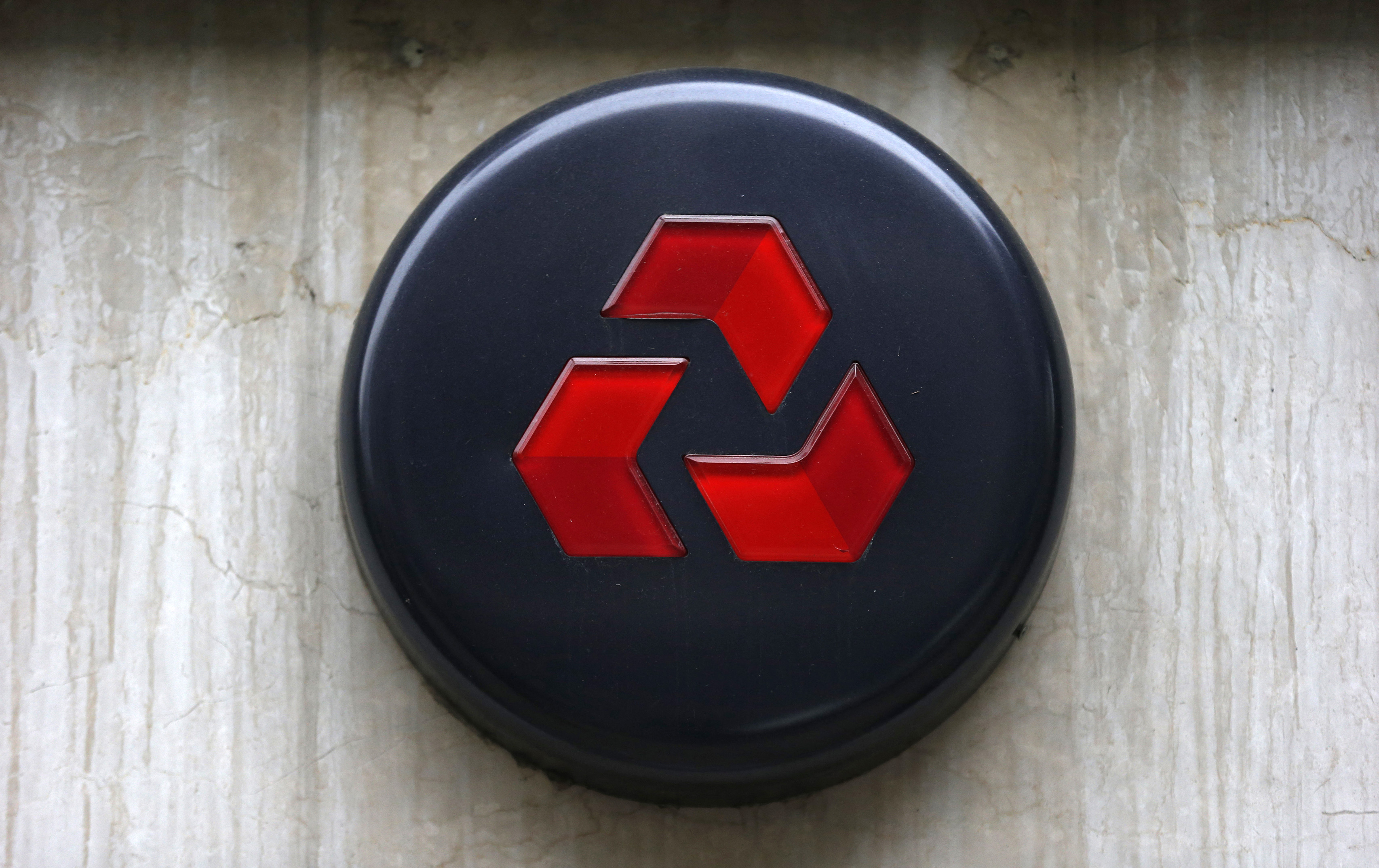 A logo is seen outside a NatWest bank branch in London