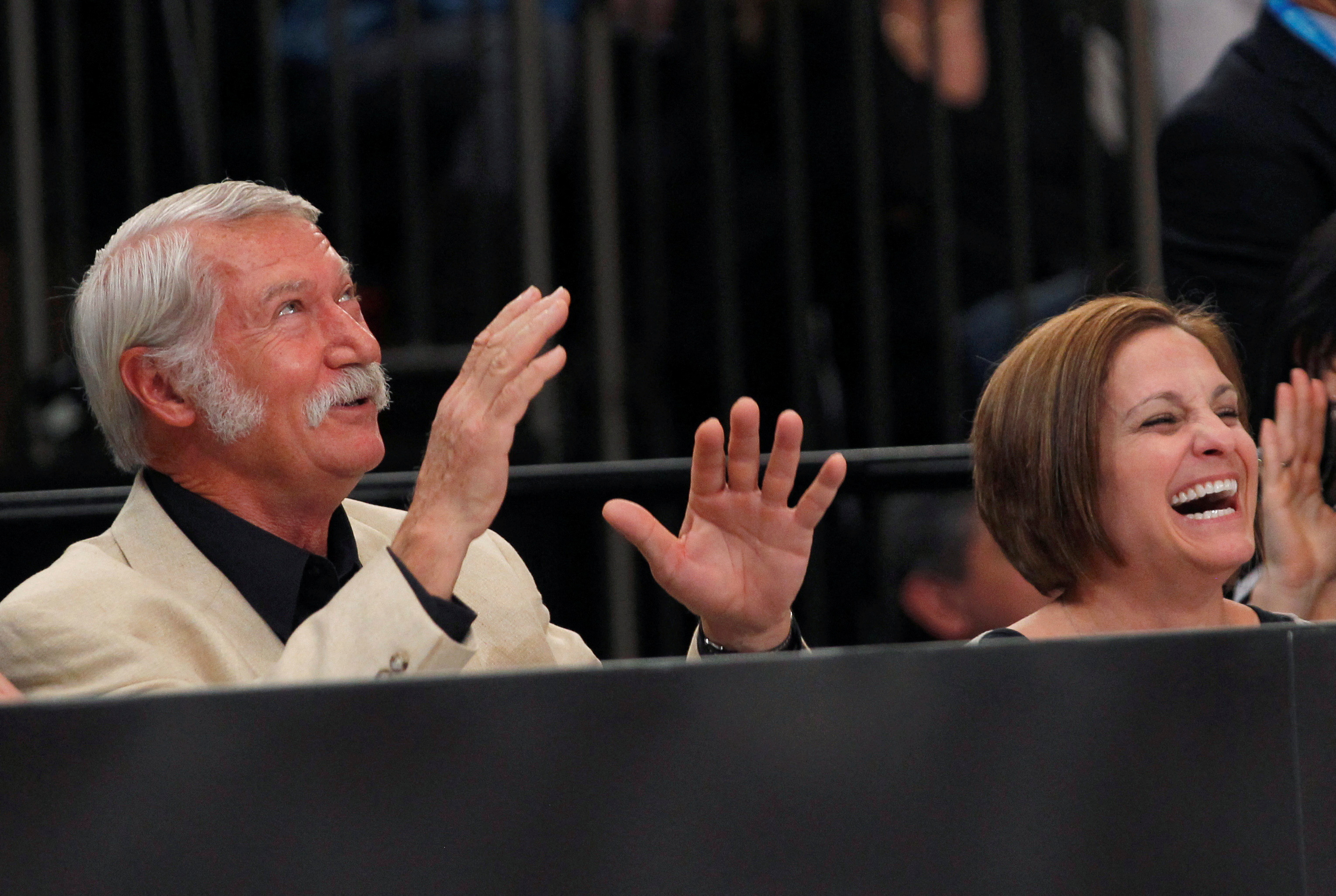 Former Olympic Gold medallist gymnast Retton of the U.S. and her former coach Karolyi laugh as they sit next to the floor during the AT&T American Cup gymnastics competition at New York's Madison Square