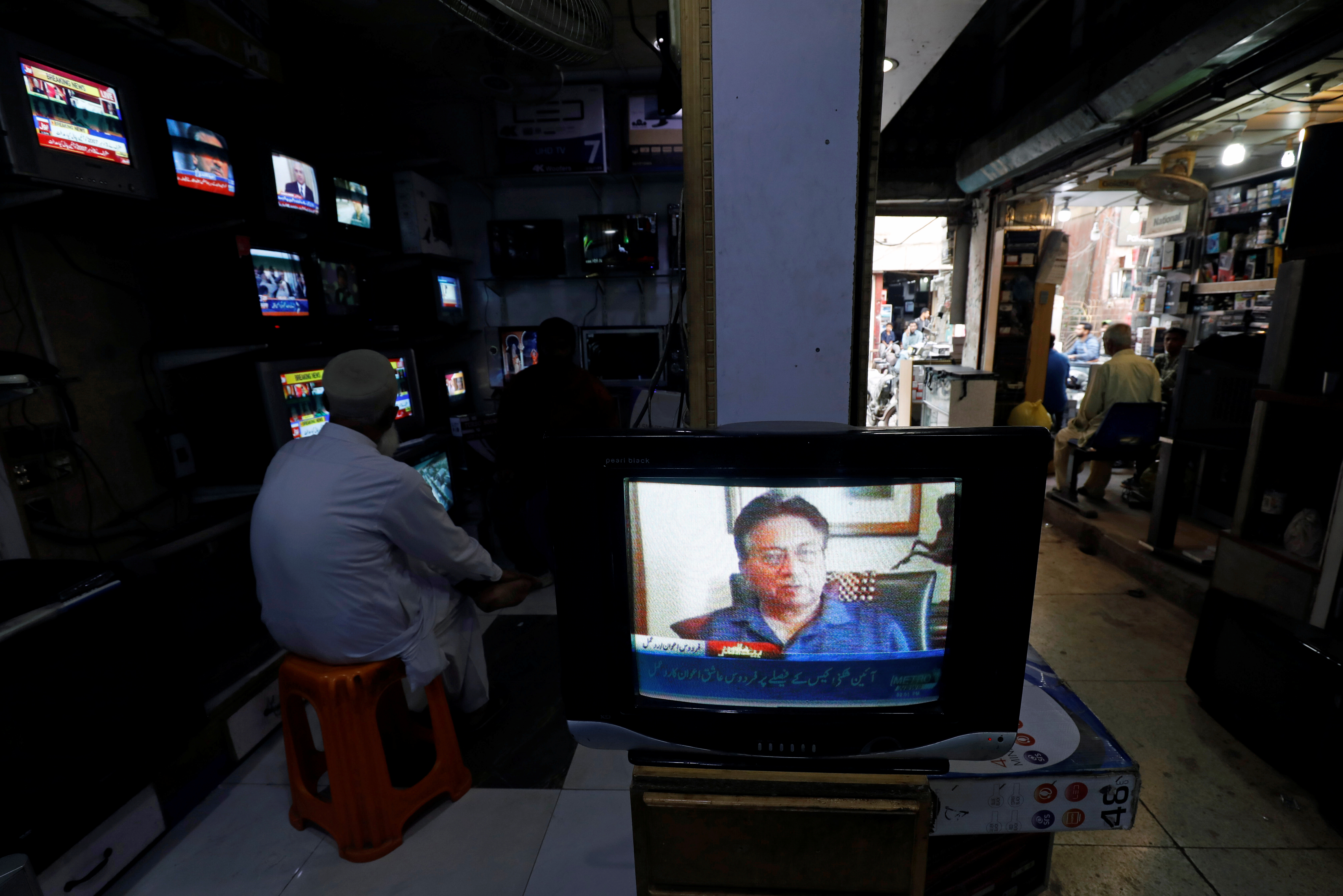 A television screen displays the news after Pakistani court sentenced former military ruler Pervez Musharraf to death on charges of high treason and subverting the constitution, at a shop in Karachi