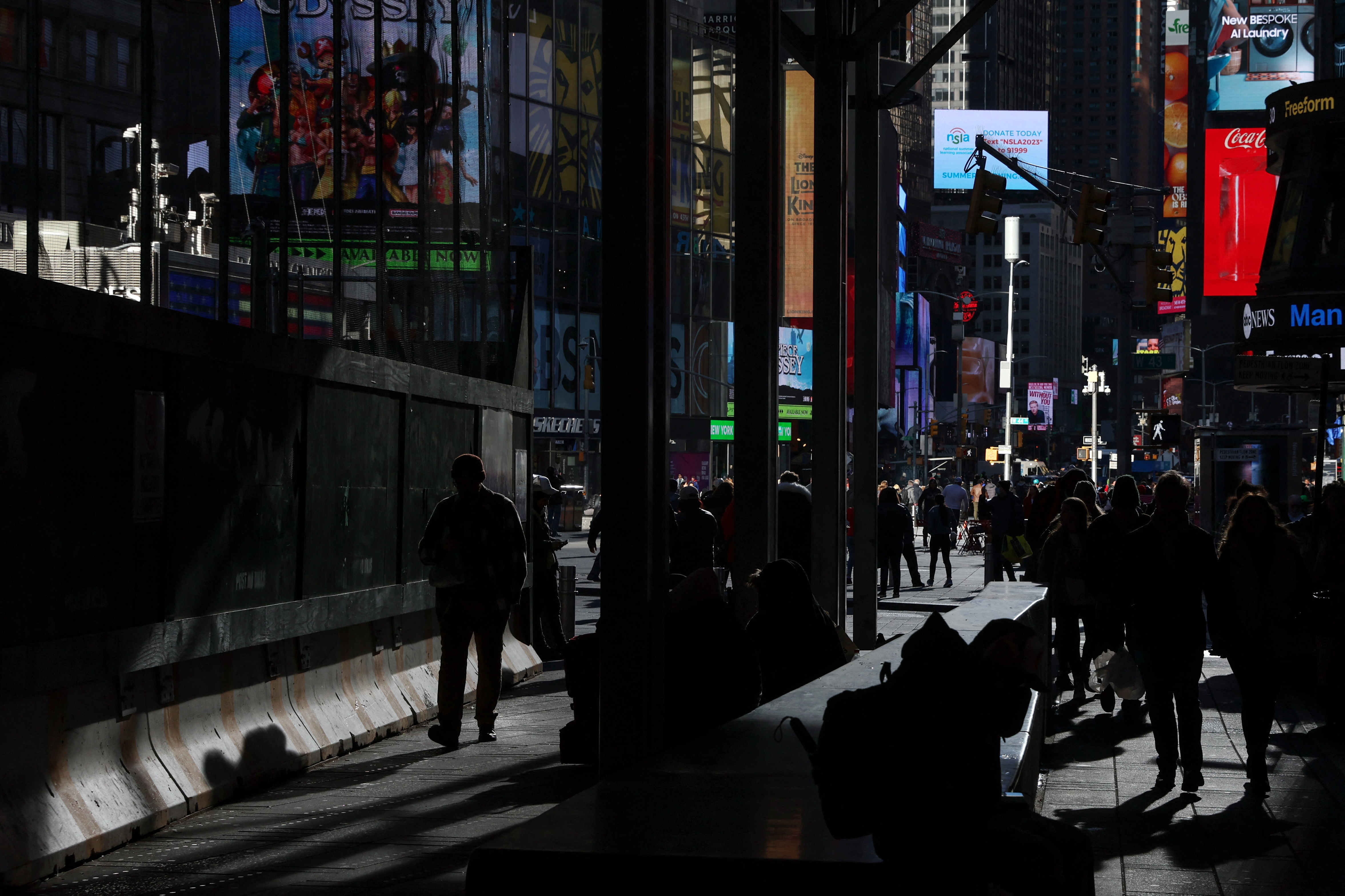 People walk through Times Square in New York City
