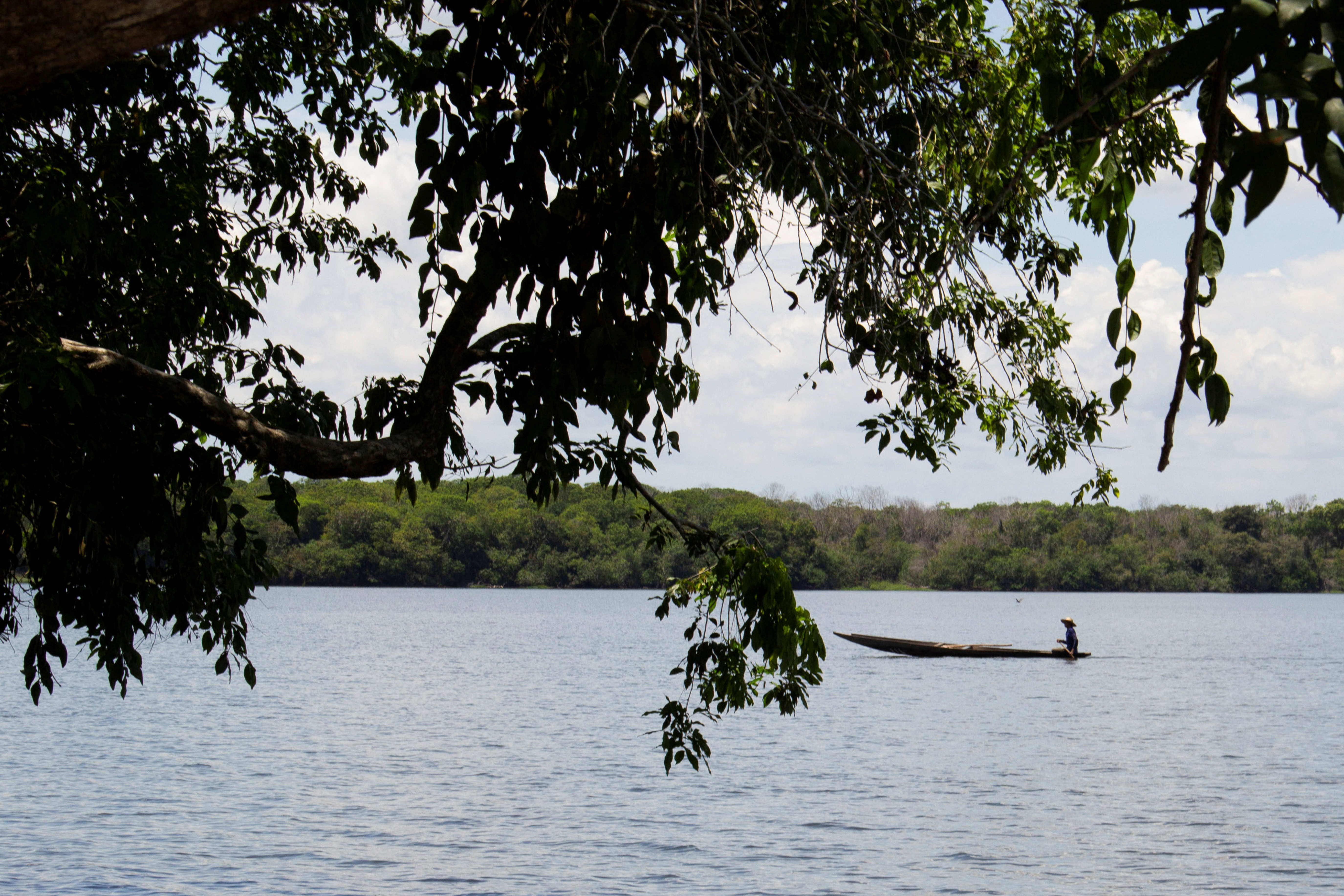 A man rides a canoe on the Magdalena River in Puerto Wilches