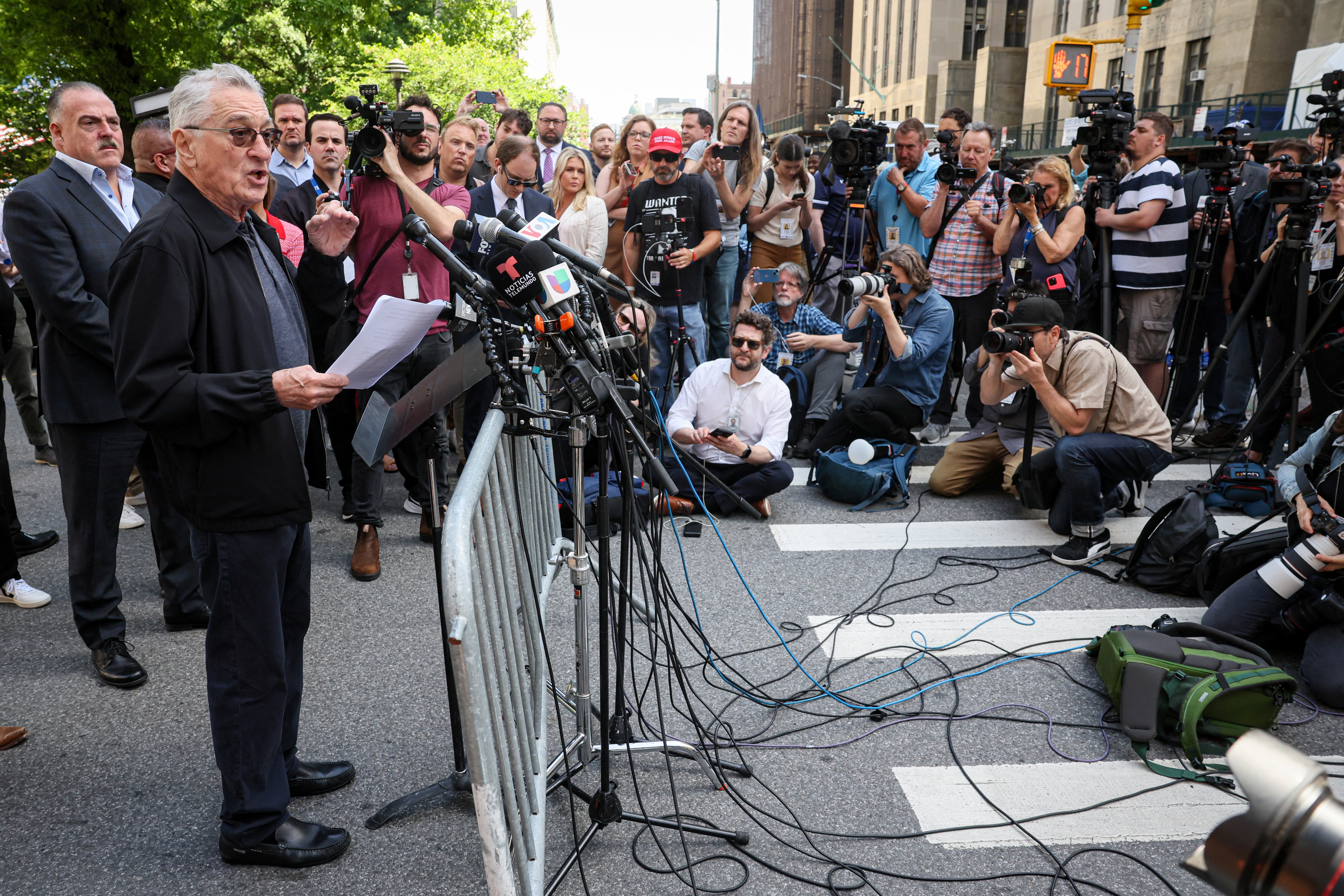 Actor Robert De Niro speaks during a news conference outside Trump trial in New York