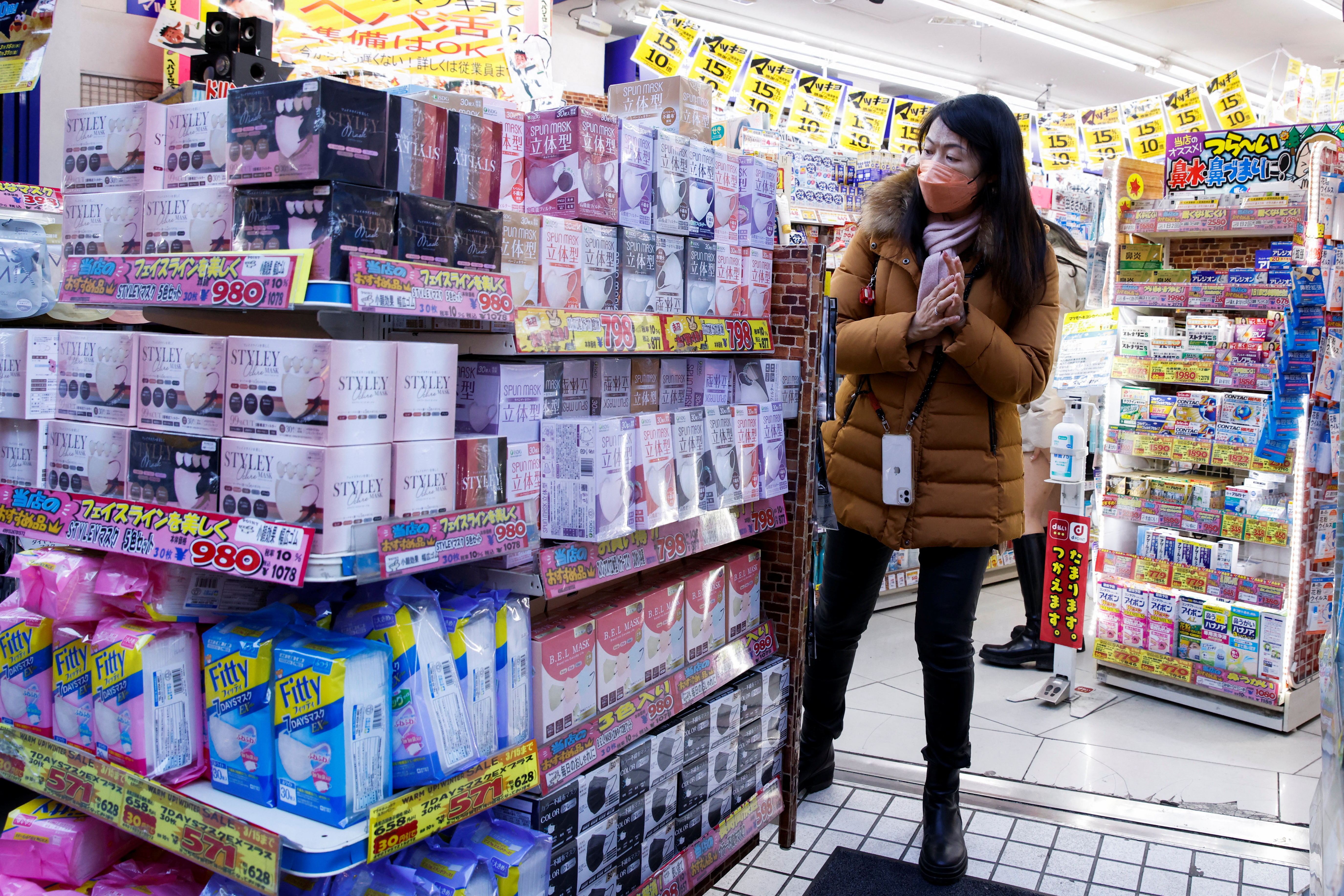 Woman shops at a pharmacy of a market in Tokyo