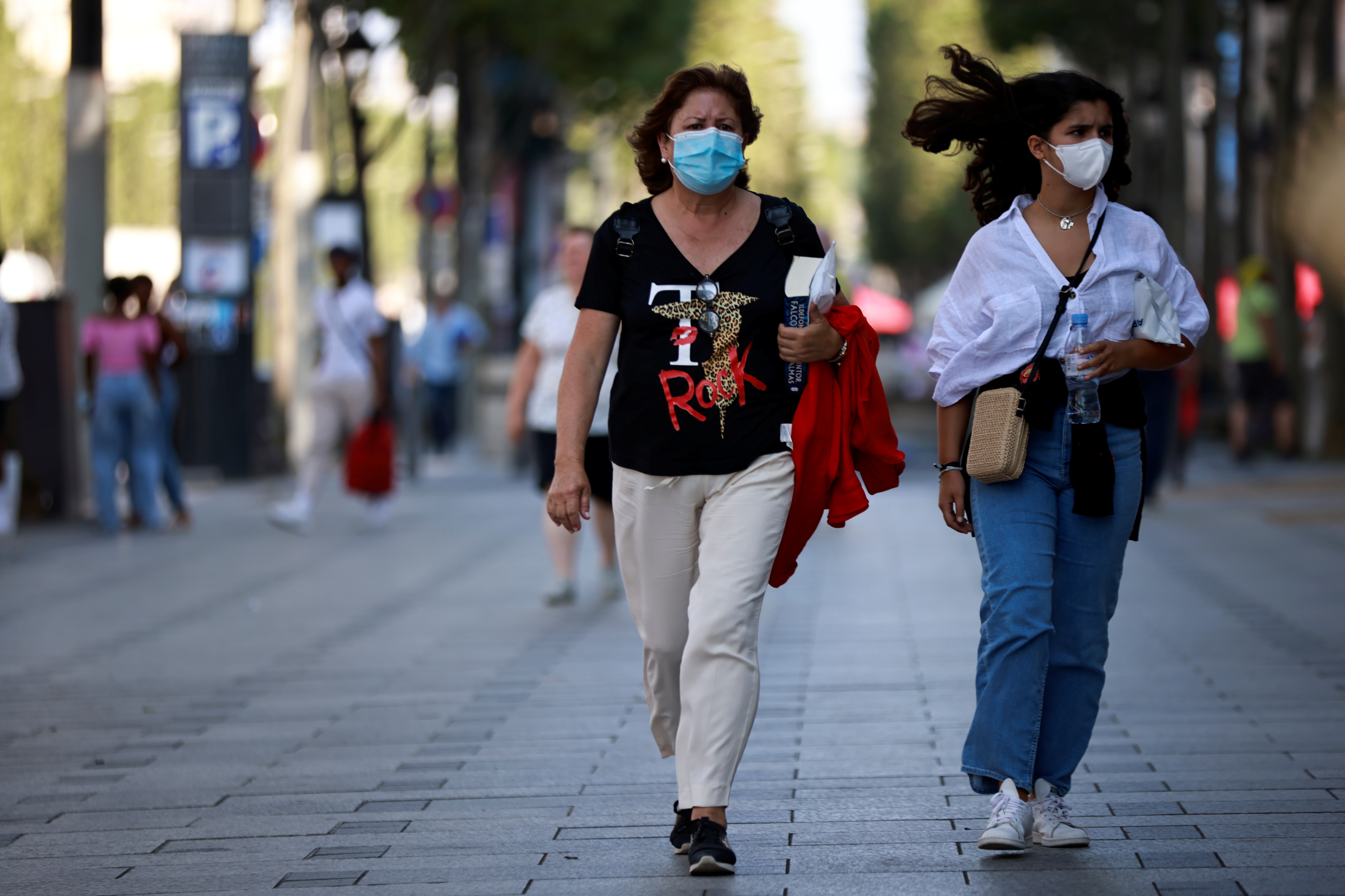 People wearing protective face masks walk on the Champs Elysees Avenue in Paris, amid the coronavirus disease (COVID-19) outbreak, in France, July 22, 2021. REUTERS/Sarah Meyssonnier