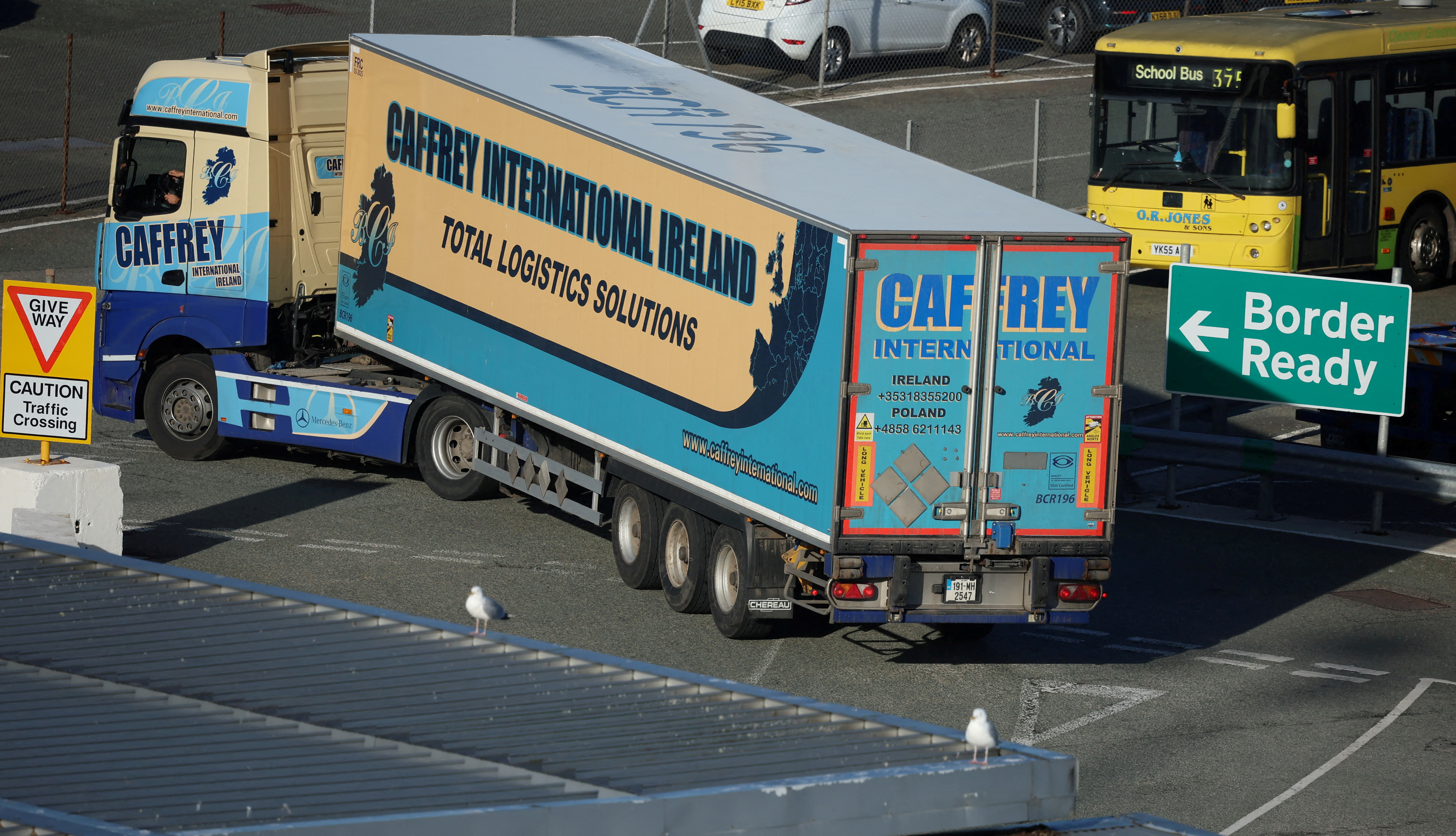 A heavy goods lorry passes a 'Border Ready' sign as it arrives to board a ferry to Dublin at the Port of Holyhead in Holyhead, Britain