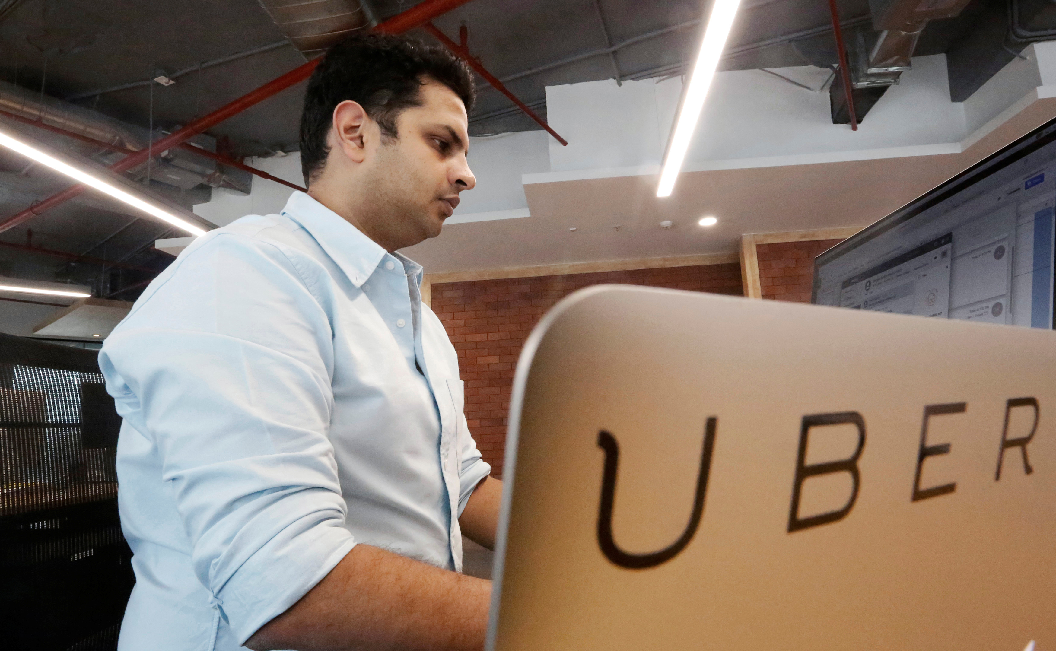 An employee works inside the office of ride-hailing service Uber in Gurugram