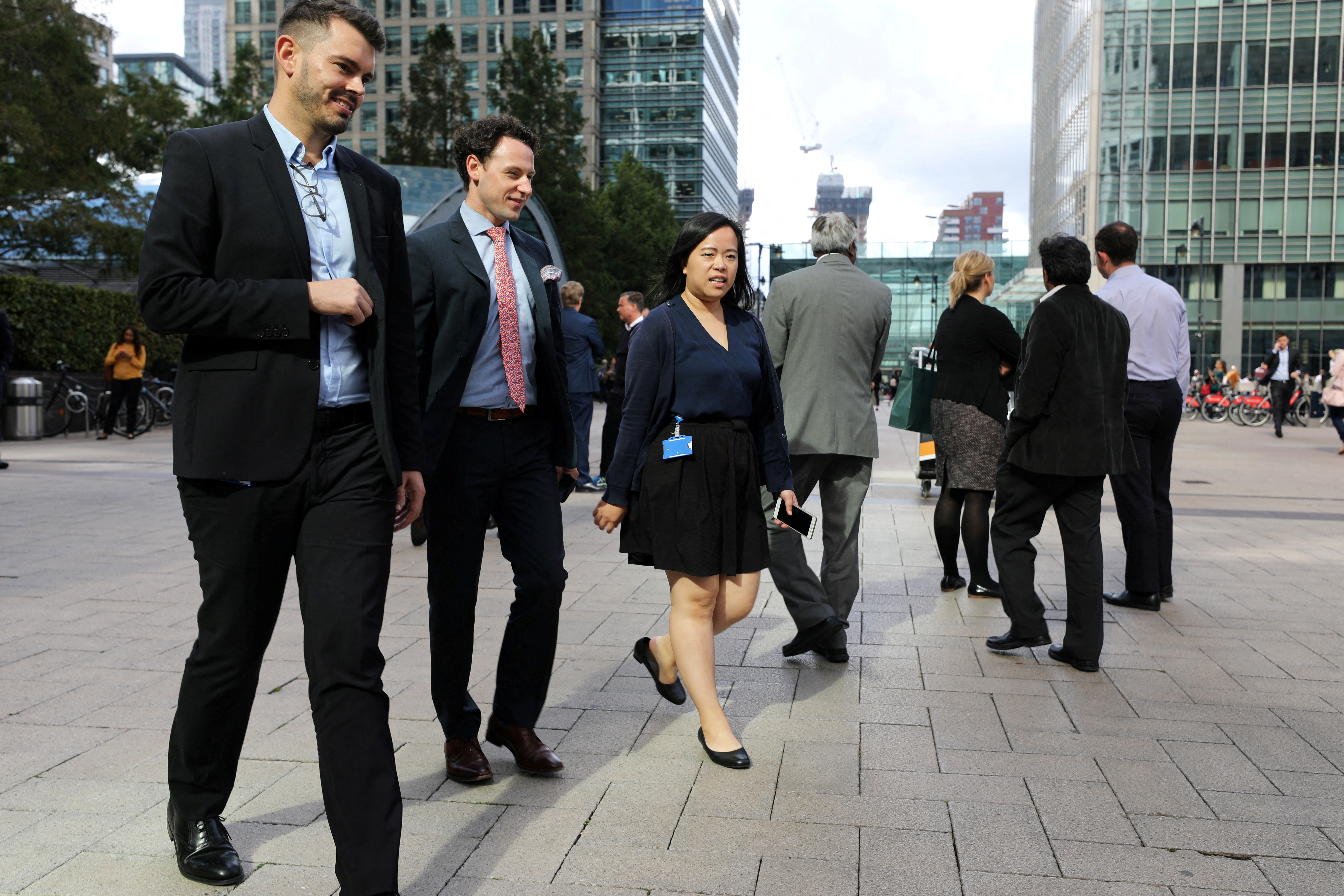 People walk through the financial district of Canary Wharf, London