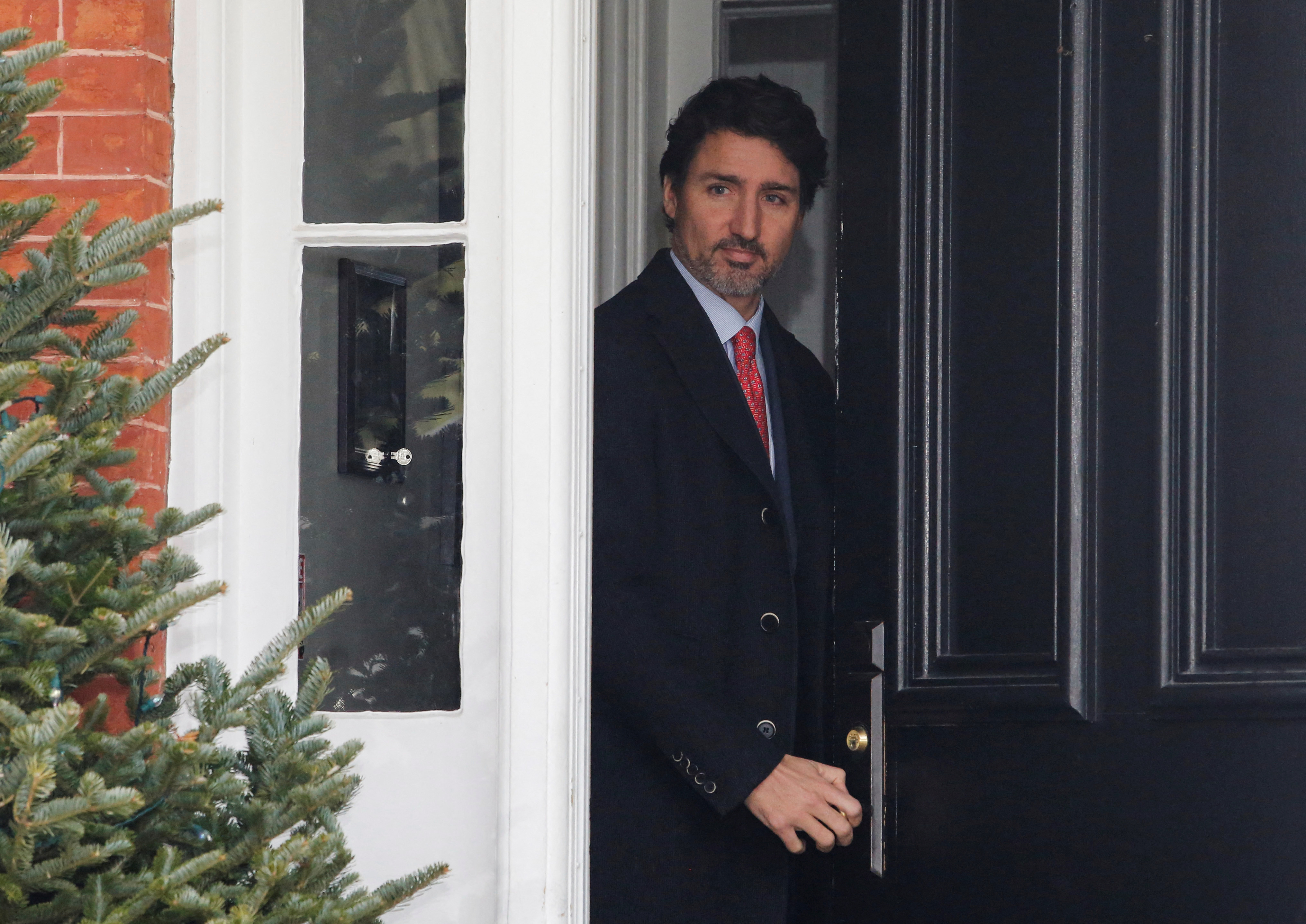 Canada's Prime Minister Justin Trudeau arrives to speak to news media outside his home in Ottawa