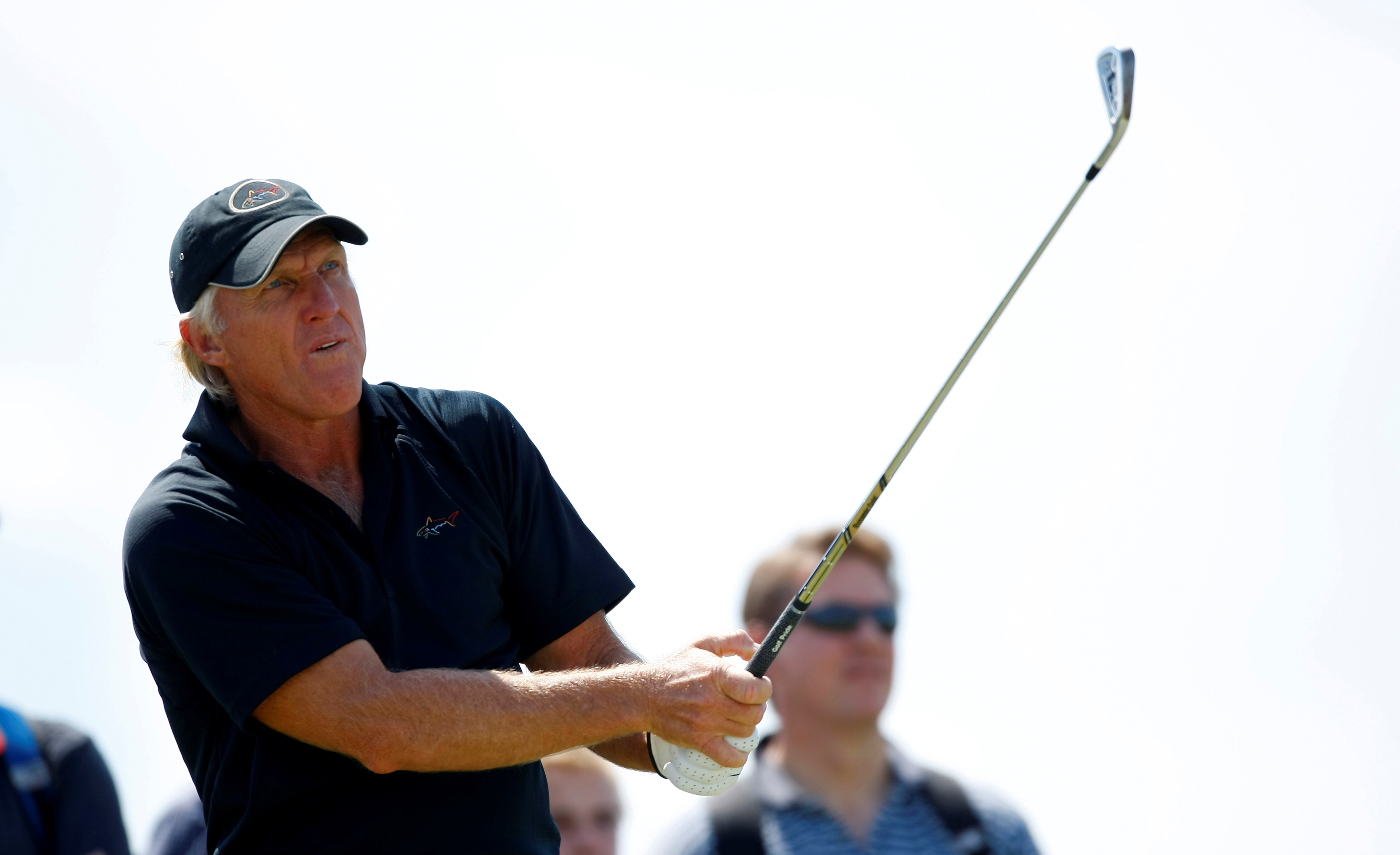 Greg Norman of Australia watches his tee shot during a practice round ahead of the British Open Golf Championship at the Turnberry Golf Club in Scotland