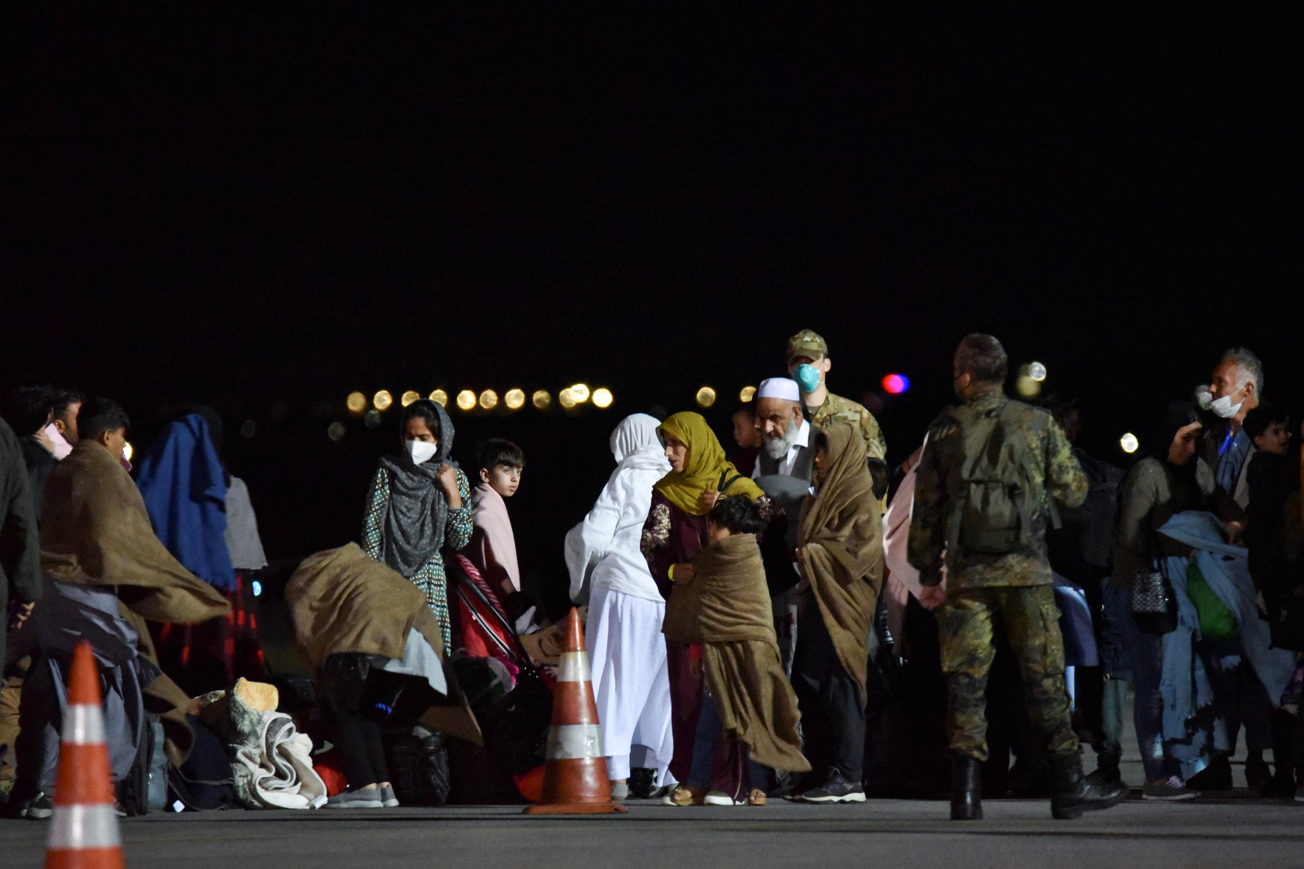 People who have been evacuated from Afghanistan arrive at Pristina International Airport in Pristina, Kosovo August 29, 2021, after Taliban insurgents entered Afghanistan's capital Kabul. REUTERS/Laura Hasani
