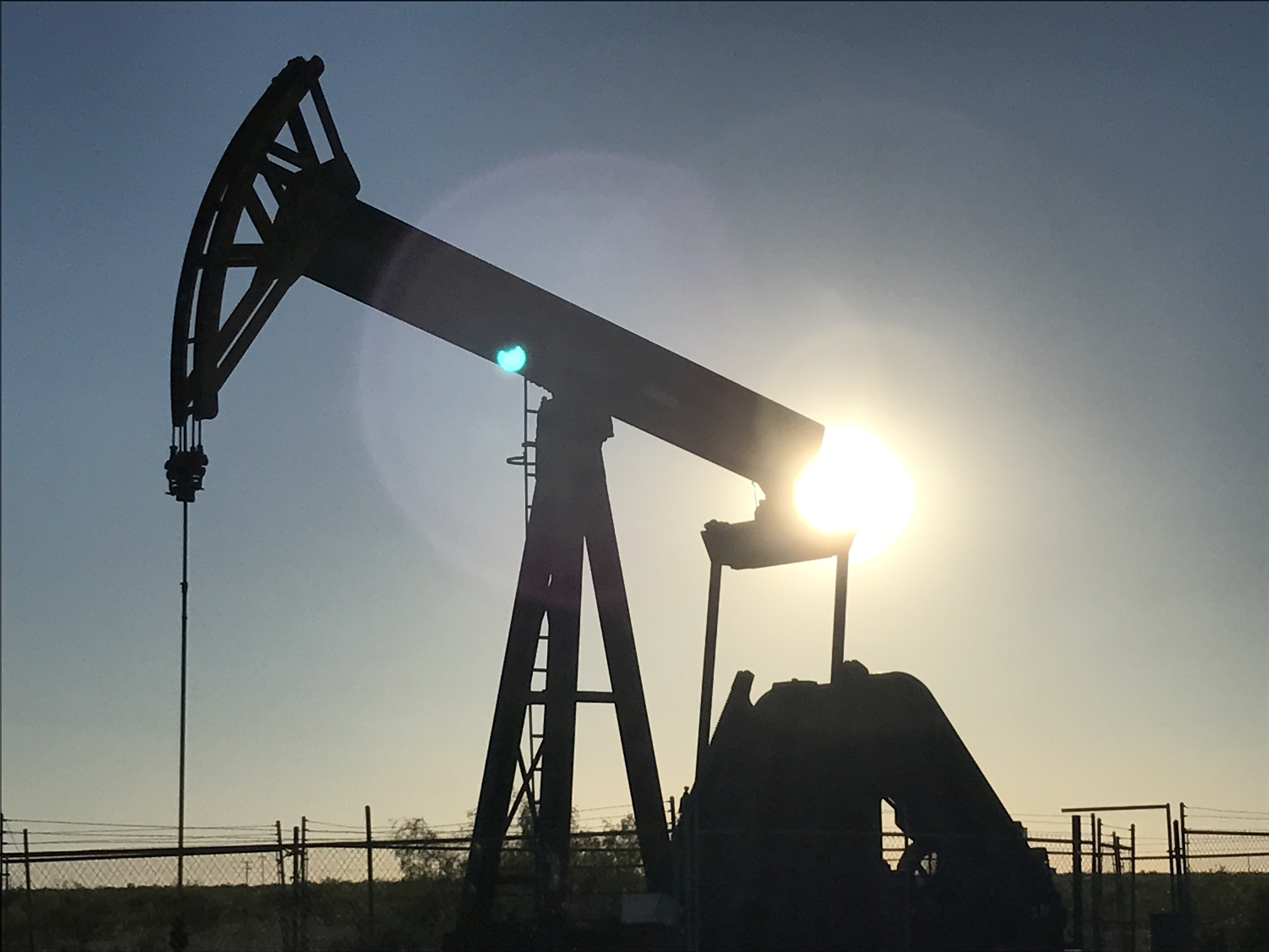 A pump jack is seen at sunset near Midland