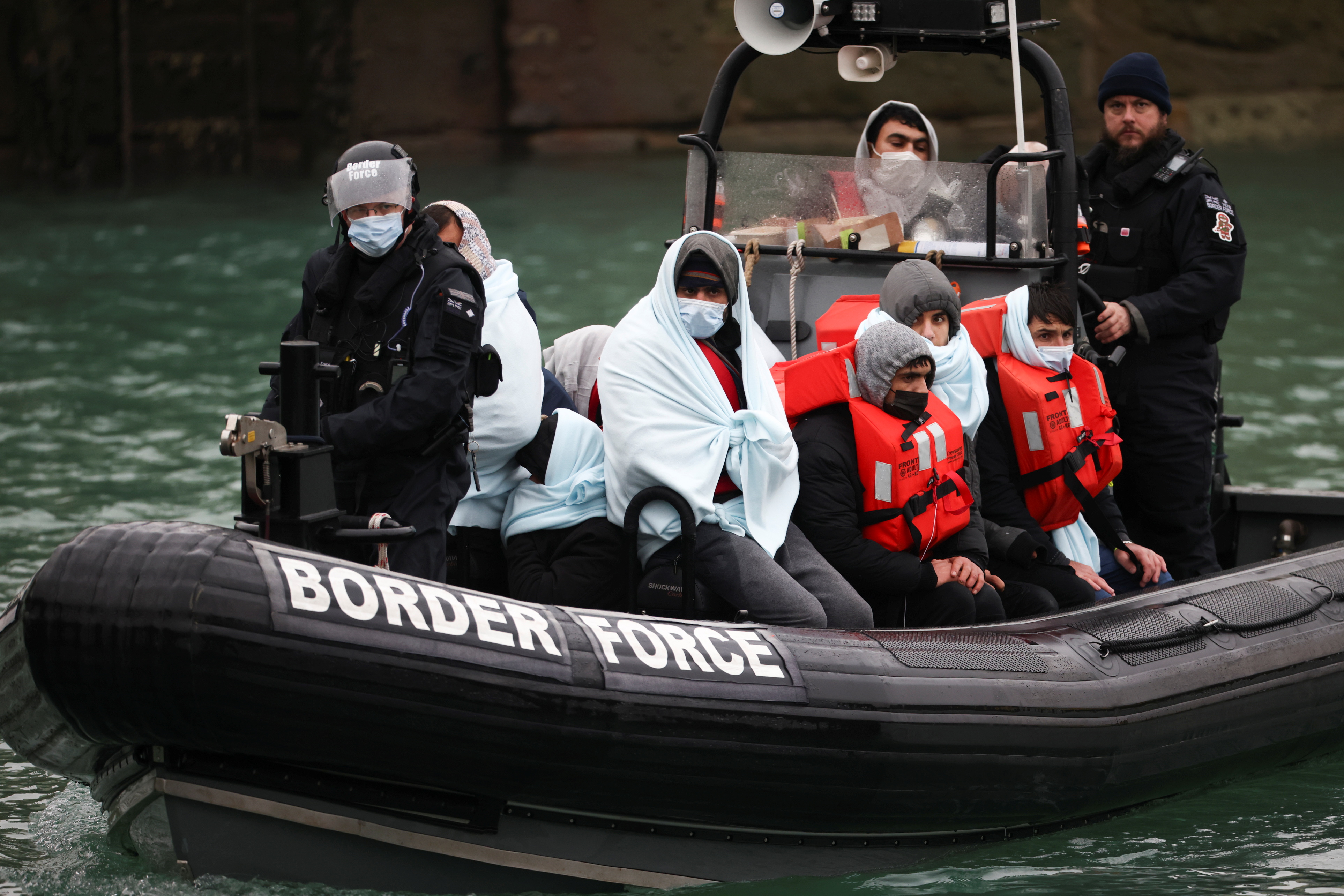 Migrants arrive into the Port of Dover onboard a Border Force vessel after being rescued while crossing the English Channel, in Dover