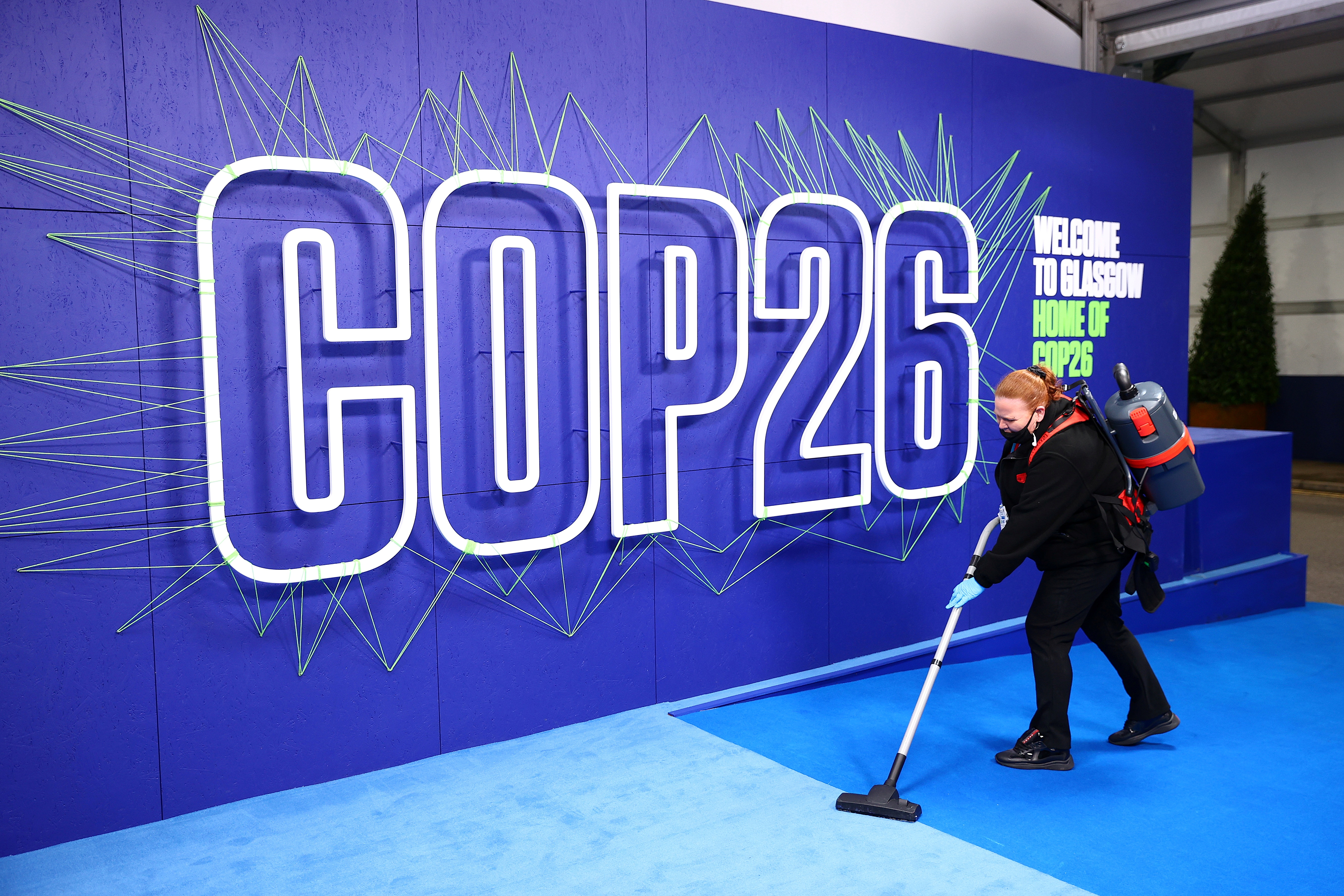 An employee cleans before the arrival of leaders for the UN Climate Change Conference (COP26) in Glasgow, Scotland, Britain November 1, 2021. Adrian Dennis/Pool via REUTERS