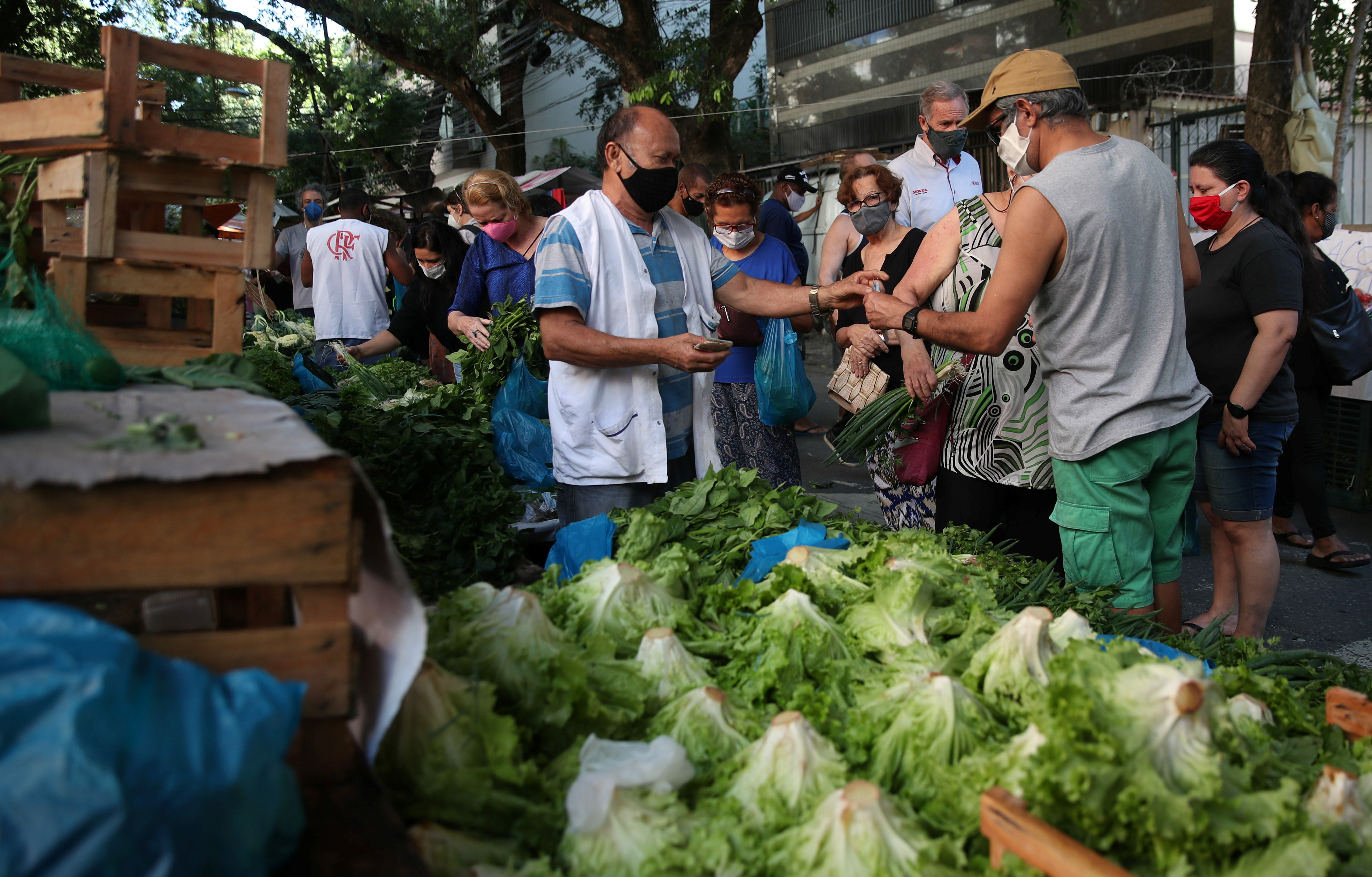 Consumers shop at a weekly street market in Rio de Janeiro