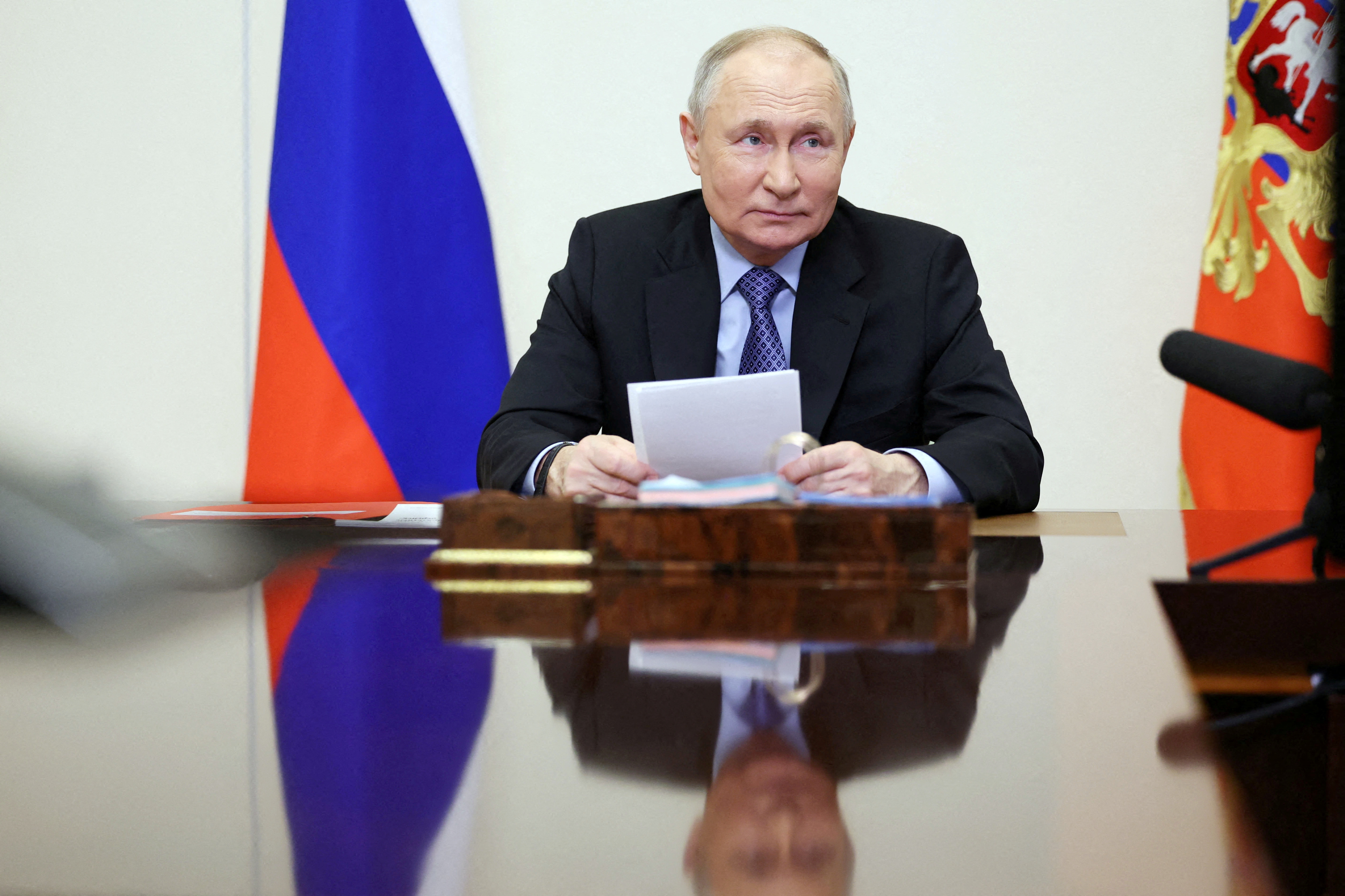Russian President Putin chairs a meeting with members of the Security Council via video link outside Moscow